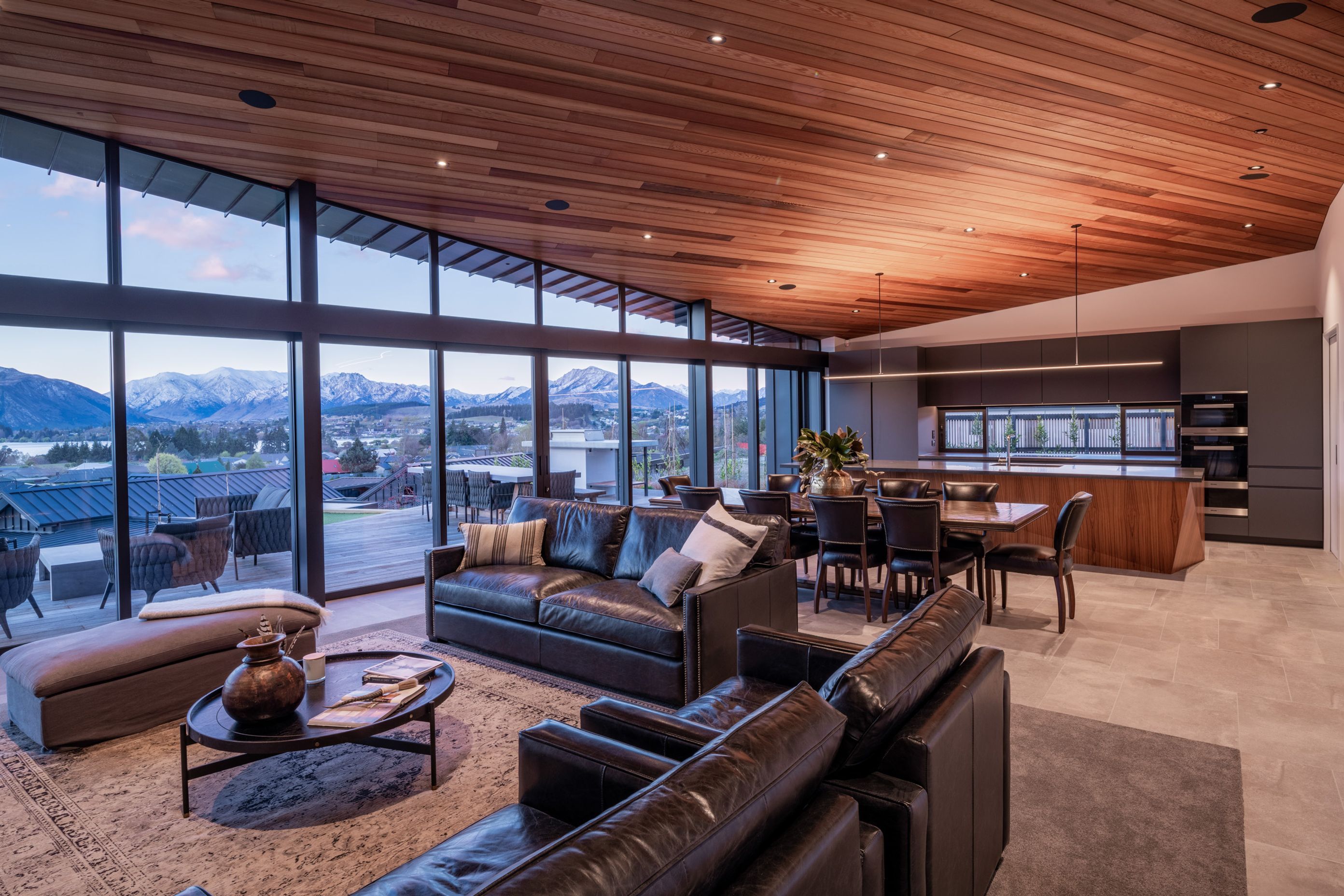 The ceiling and kitchen island feature timber, which has the effect of warming the space.