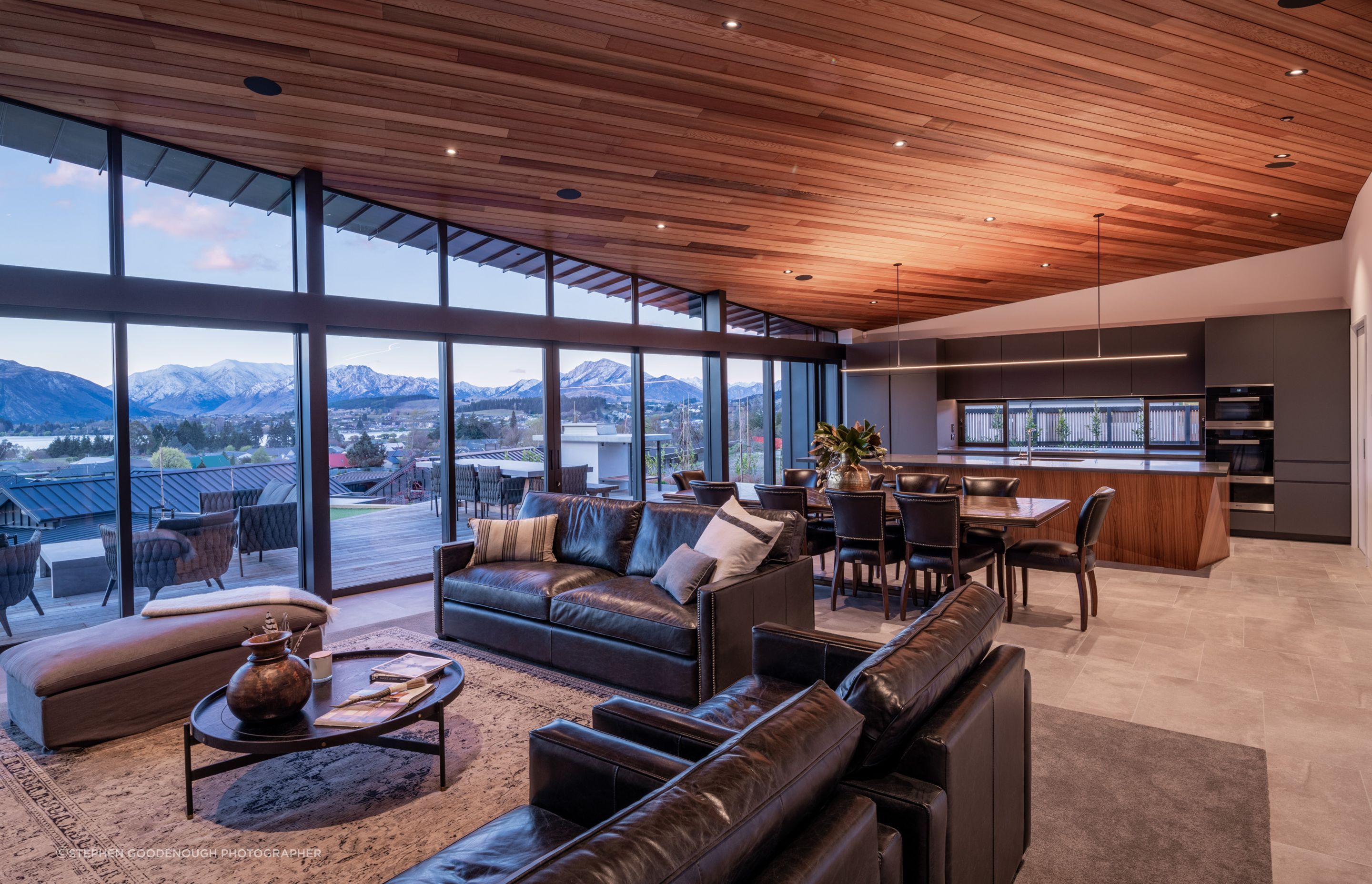 The ceiling and kitchen island feature timber, which has the effect of warming the space.