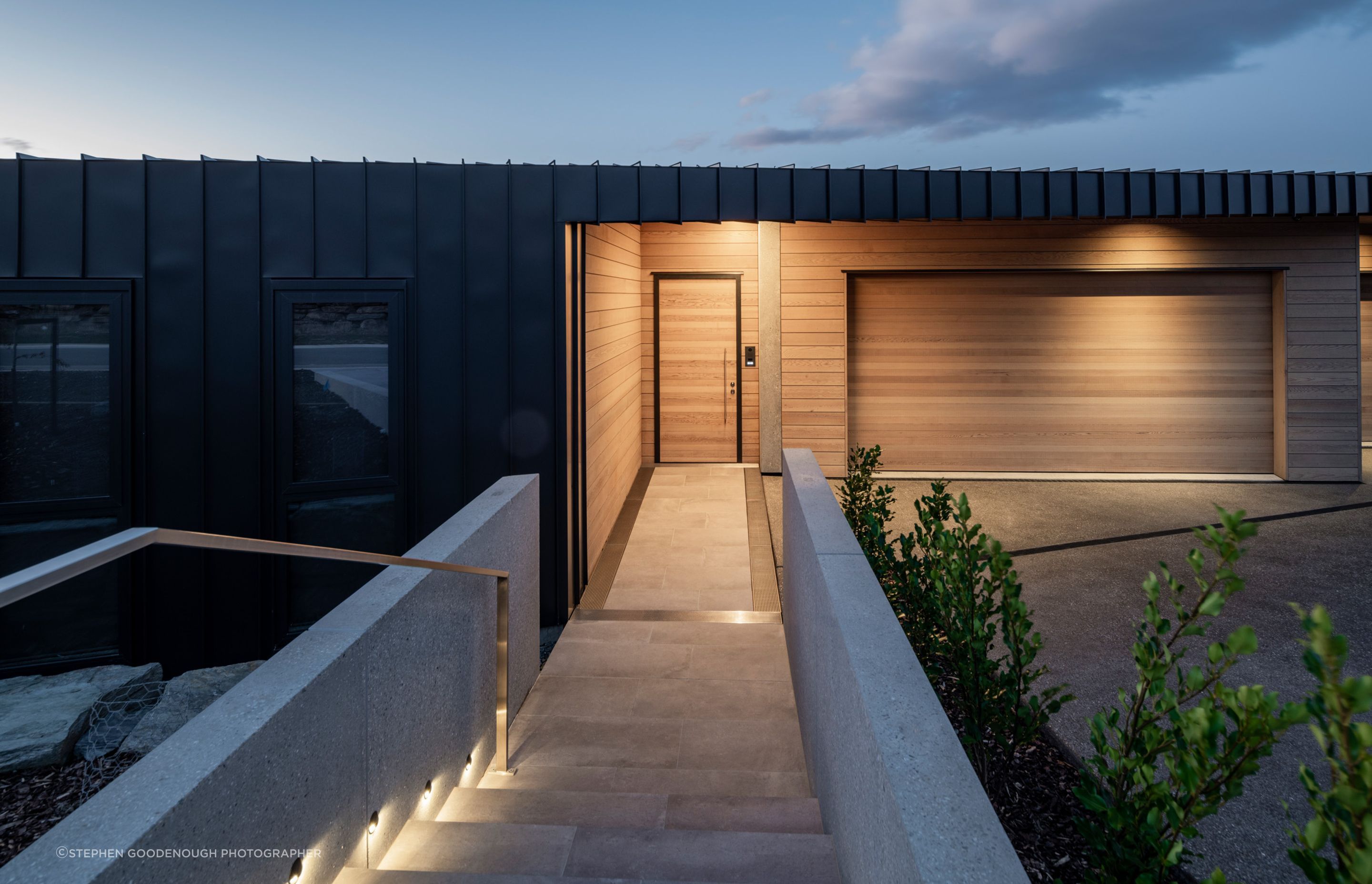 Entry spaces are accentuated with cedar to break up the black metal cladding.