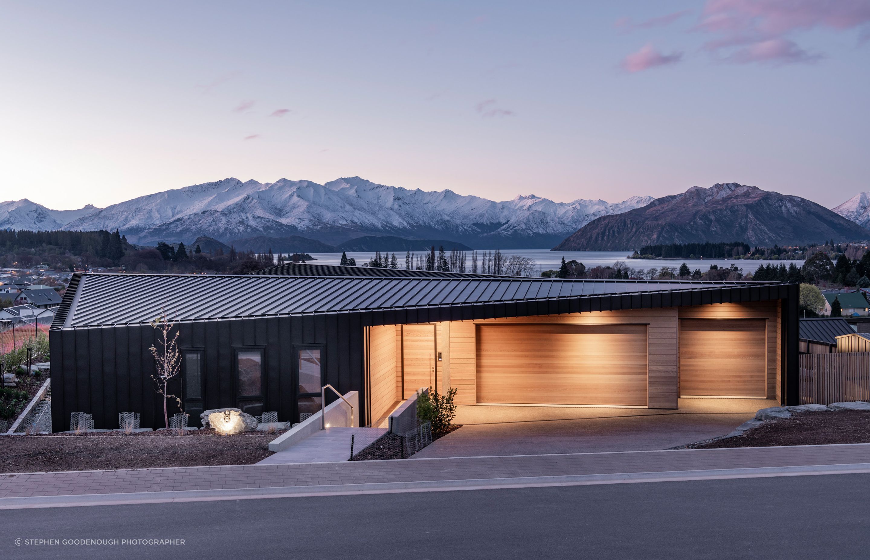 From the street, the origami-like roof draws attention to the neat geometry of the building.