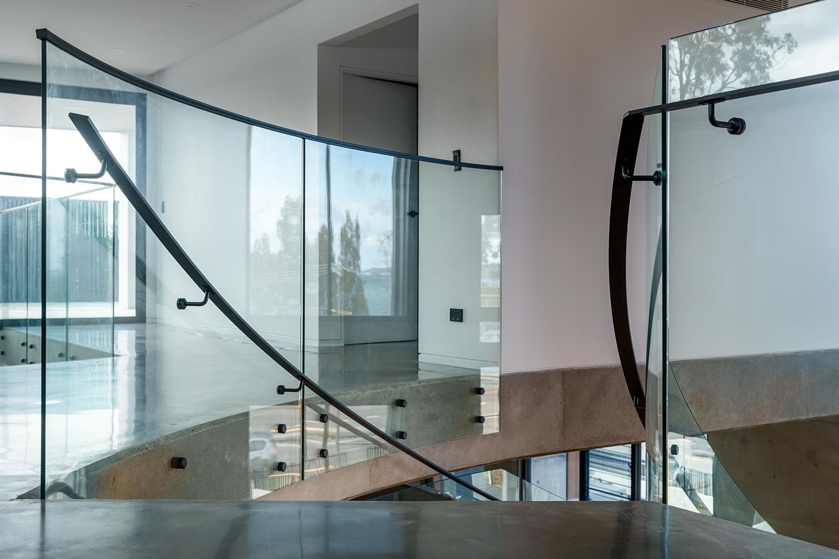 The Esplanade – Twin Bent Glass Curved Staircase