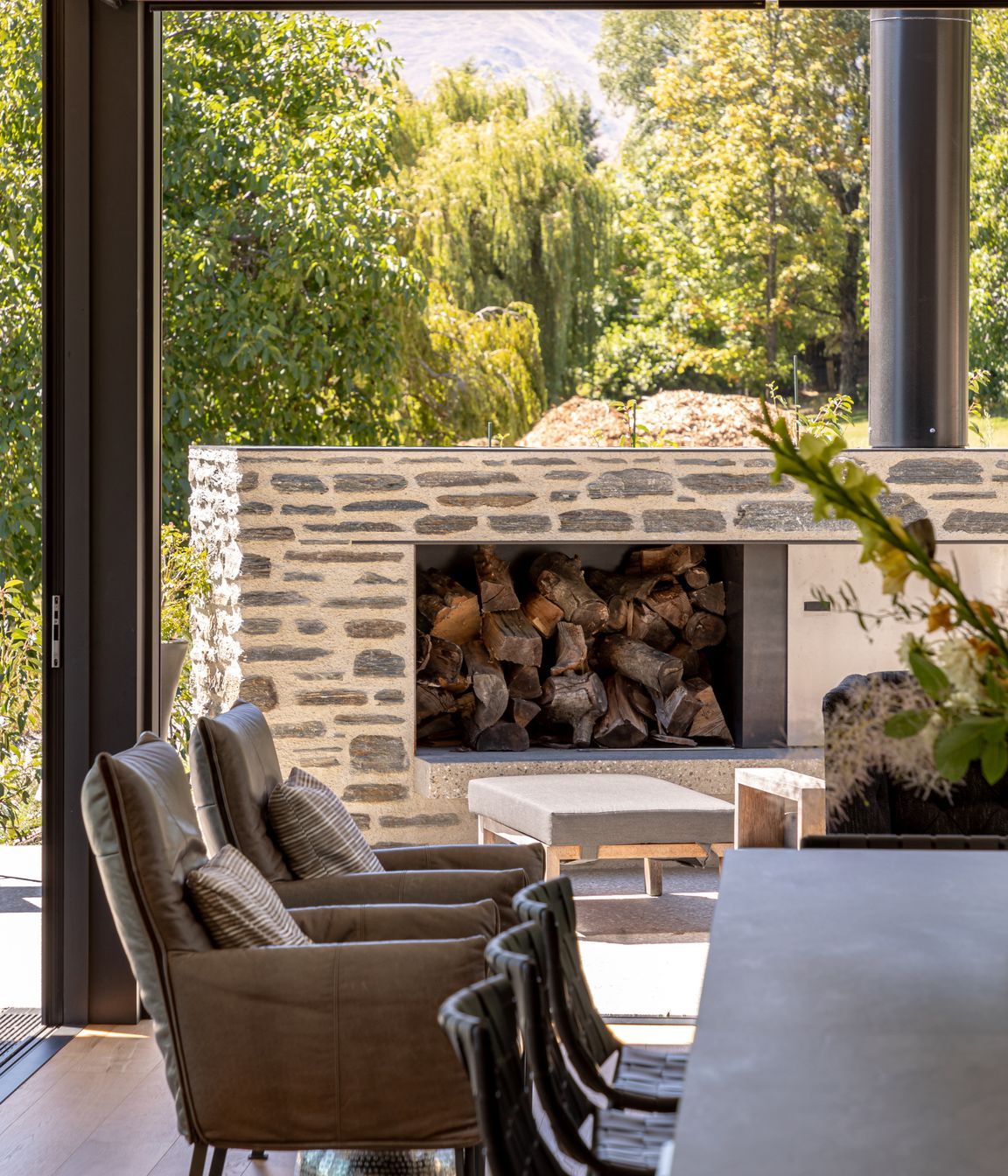 032-Ben-Hudson-Architects-Lake-House-outdoor-fire-and-dining.jpg