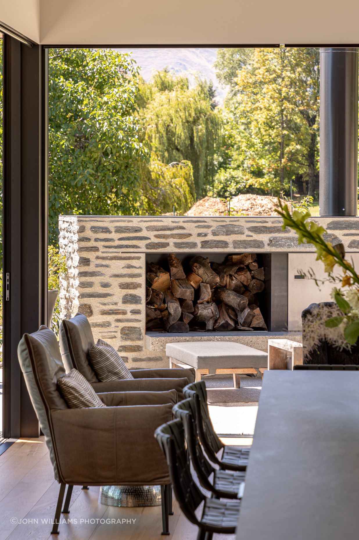 032-Ben-Hudson-Architects-Lake-House-outdoor-fire-and-dining.jpg