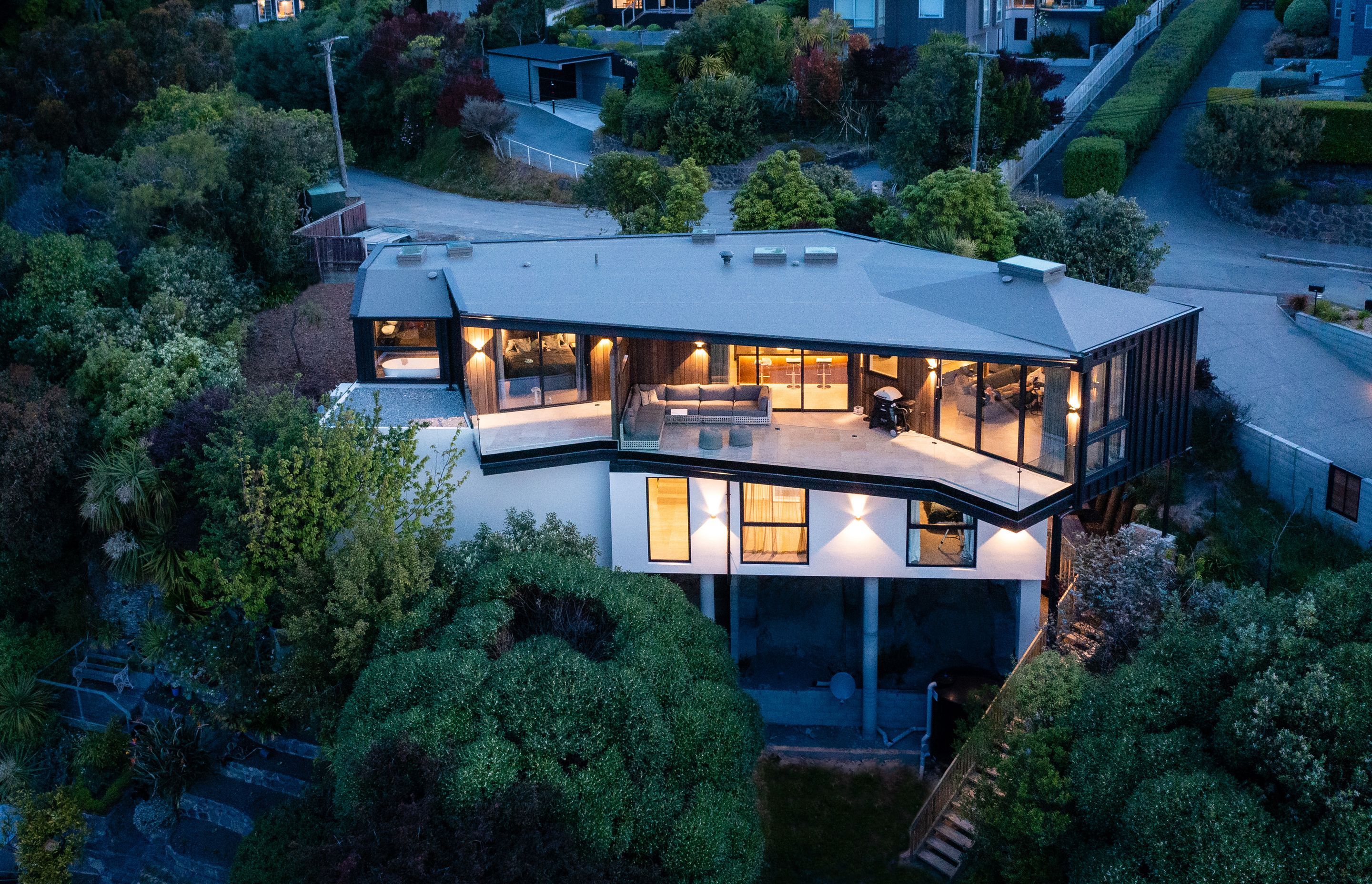 The existing greenery on the site was retained so that the home nestles easily into the landscape.