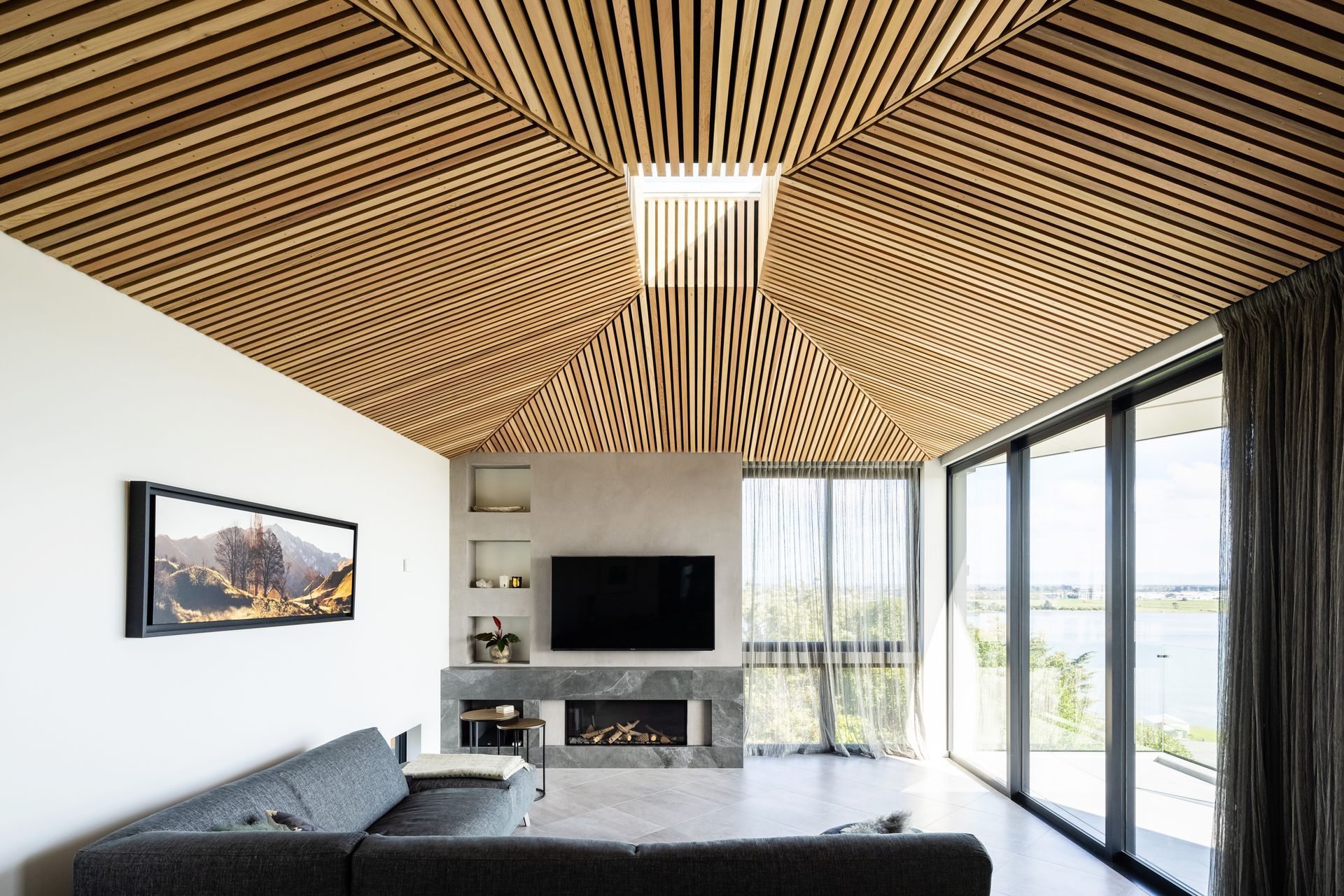 The battened cedar ceiling soars towards a central operable skylight.
