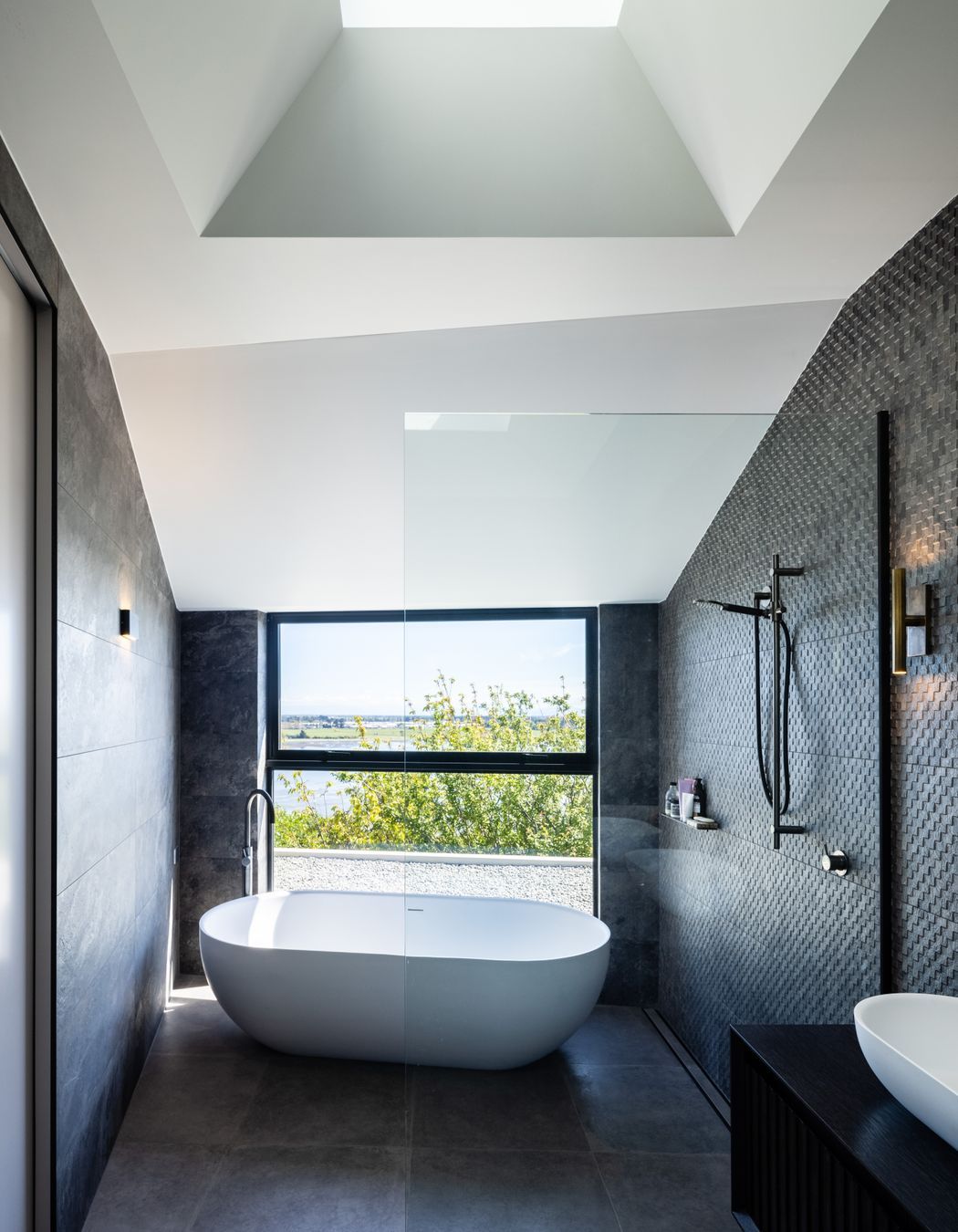 The master en suite bath and shower enjoy a dramatic view.