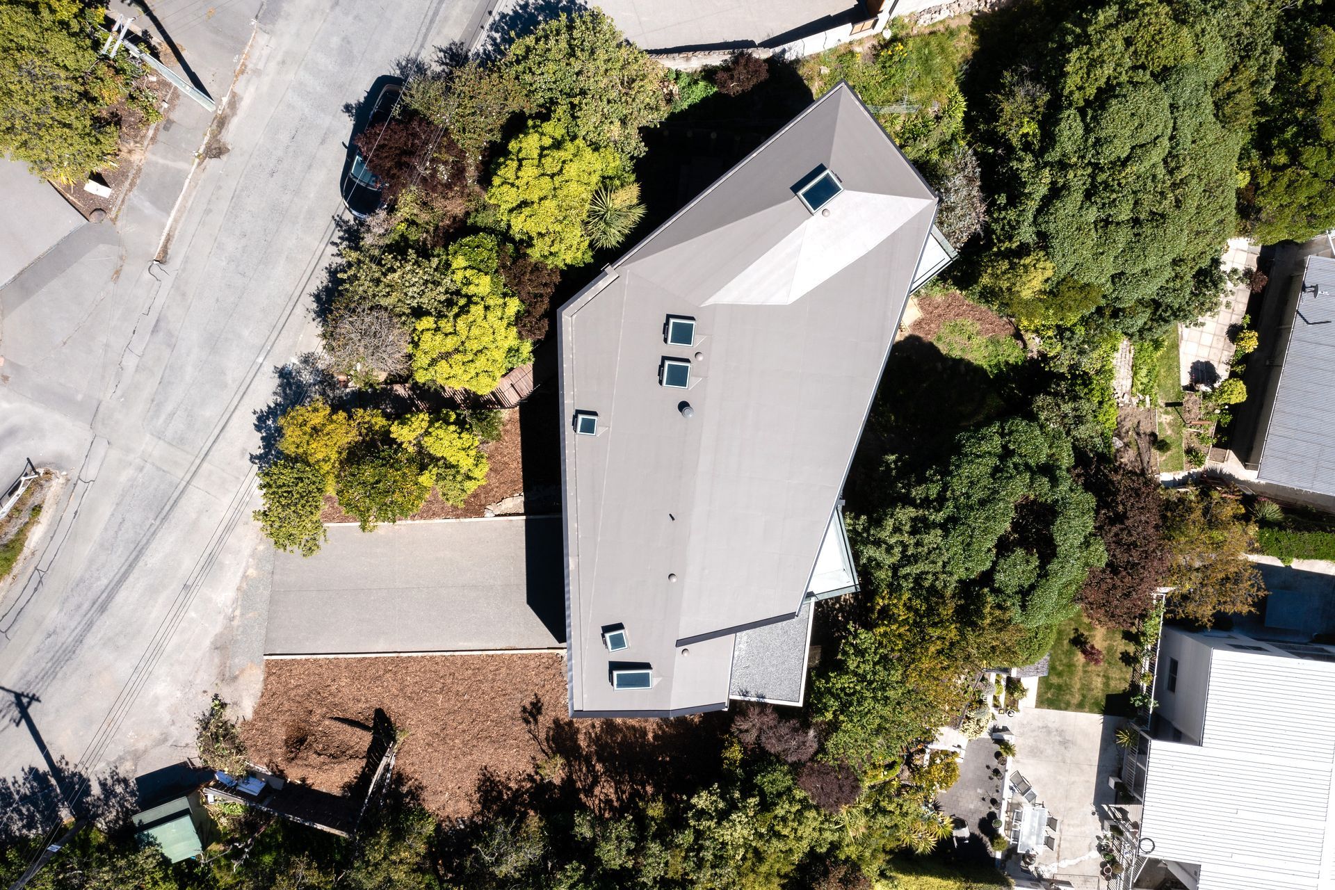 A view from above shows a boomerang shape that allows a sheltered outdoor space in the fold.