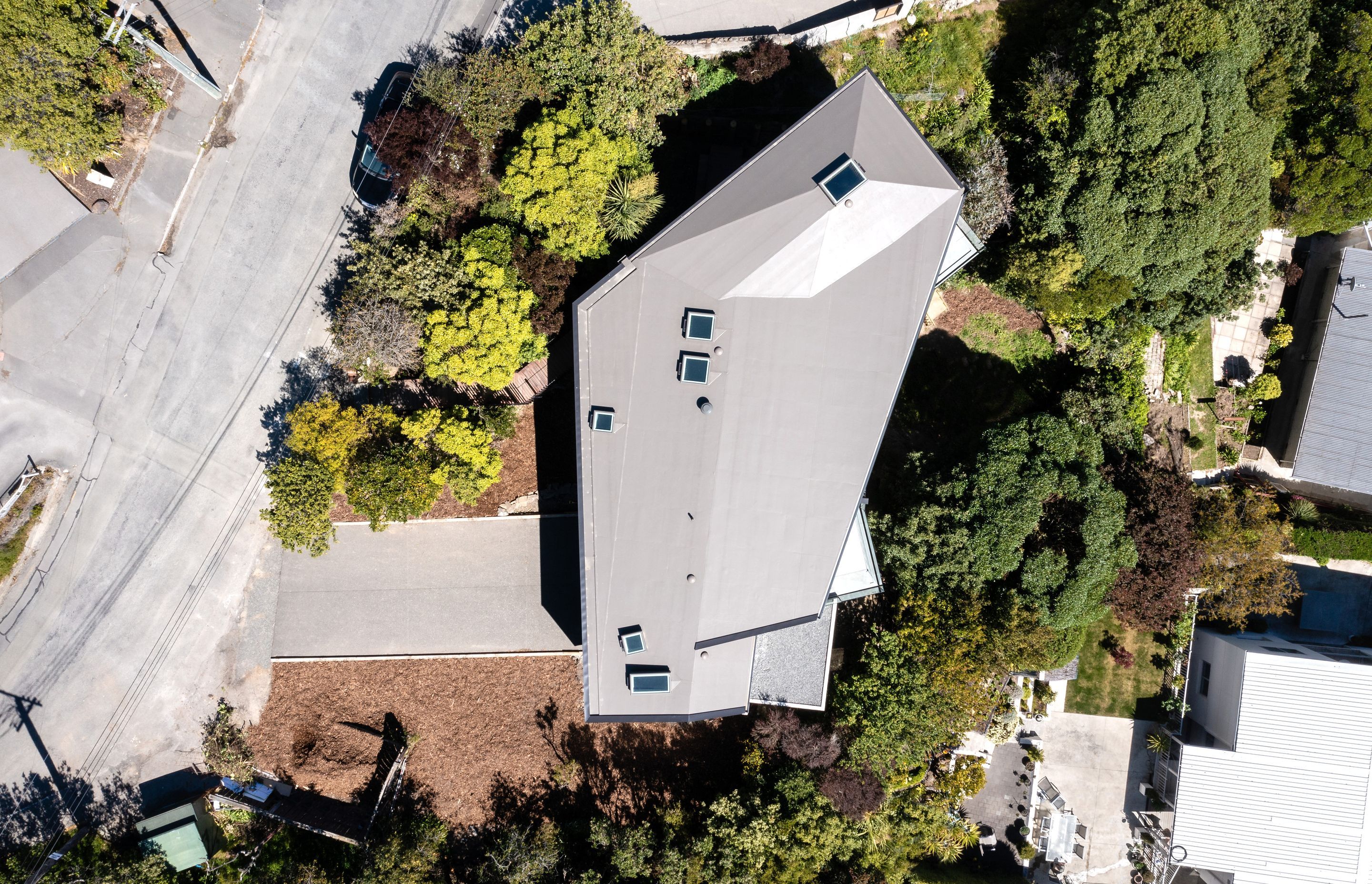 A view from above shows a boomerang shape that allows a sheltered outdoor space in the fold.