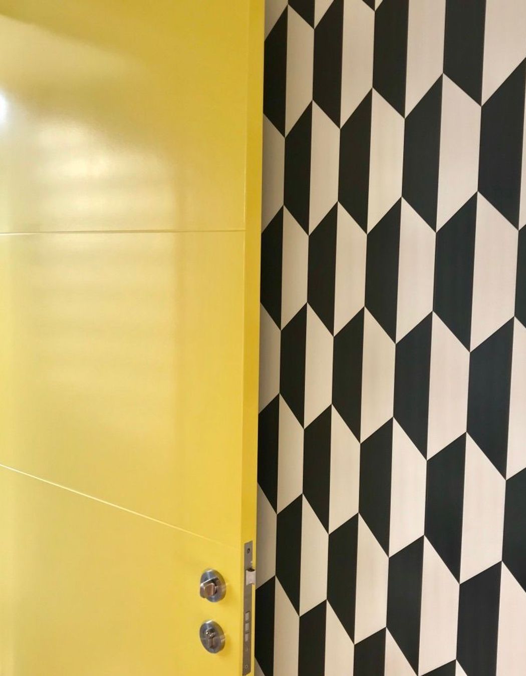 How's this for a joyful entrance! Resene Turbo opening onto a classic black and white geometric wallpaper in the St Albans new build.