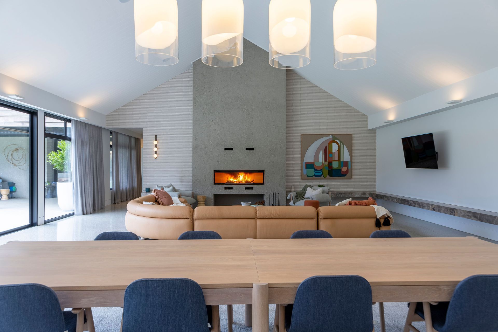 Nestle into the cozy embrace of our lounge room, adorned with a magnificent large wood fireplace, where warmth and ambiance merge to create the perfect setting for relaxation and cherished moments