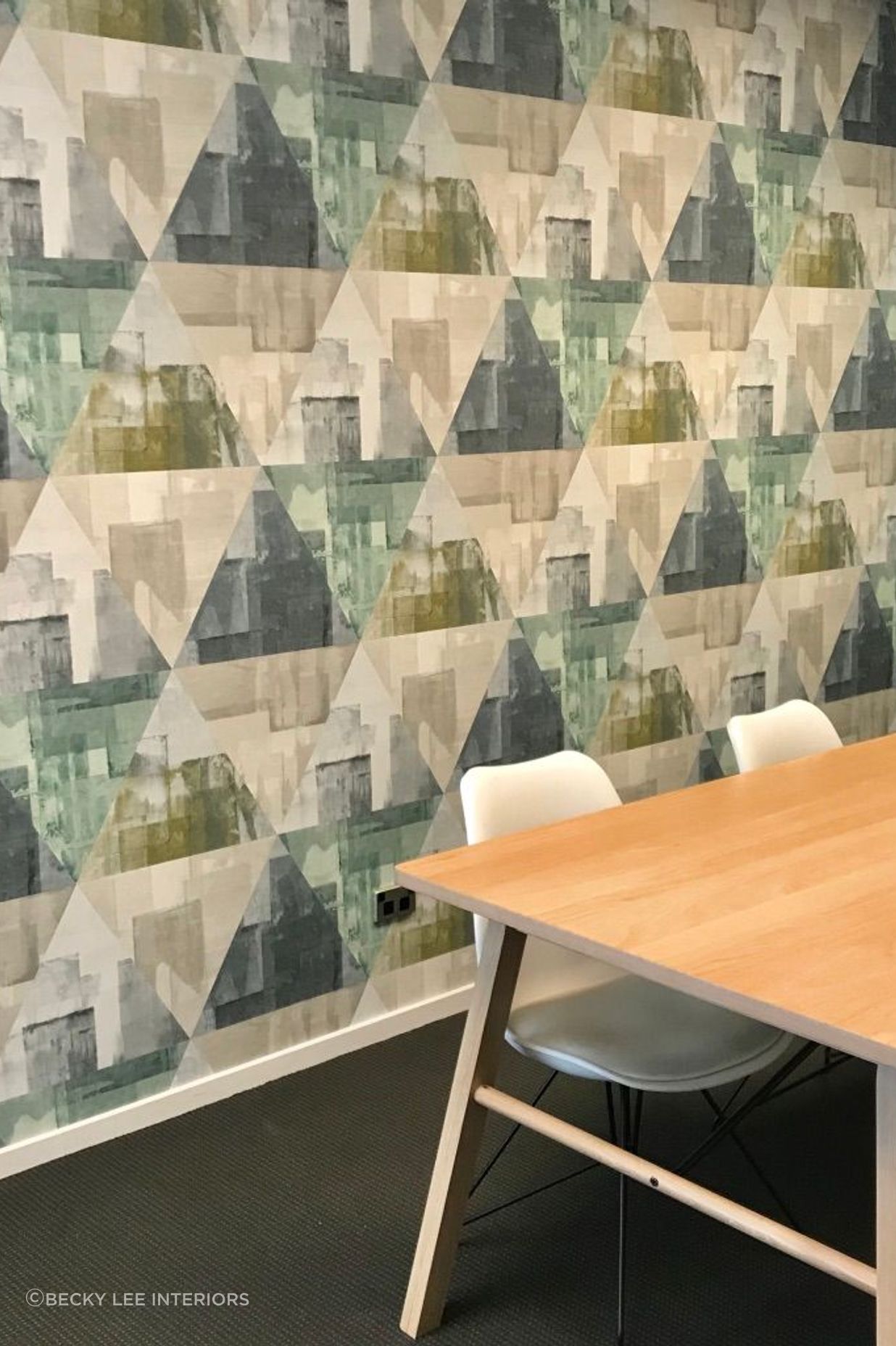 Wallpaper in a large scale mid century inspired design makes a statement in this boardroom space.