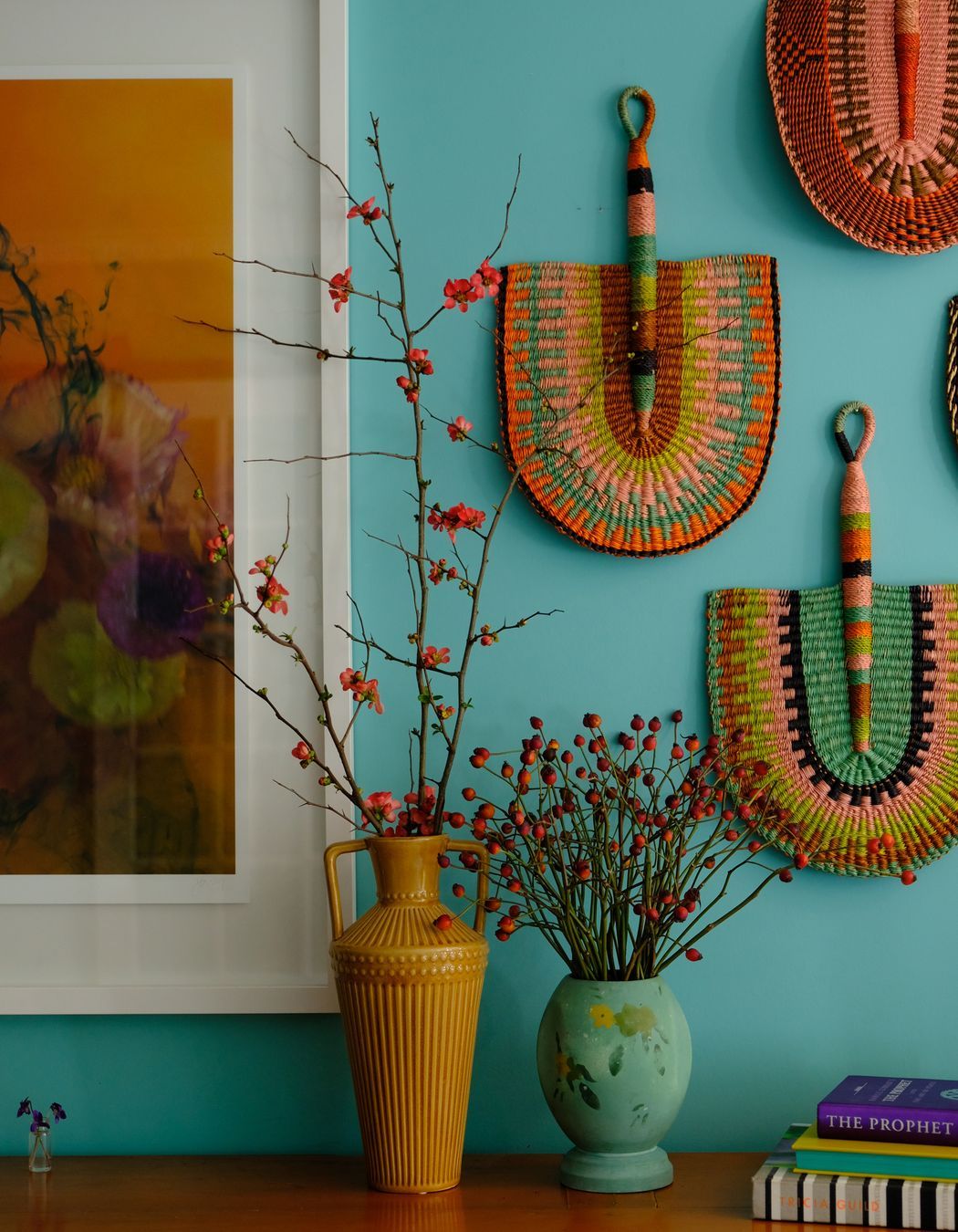 Handmade fans from Ghana looking striking against the Resene Gulf Stream wall. Artwork 'Mermaid Like' by Stacey Weaver.