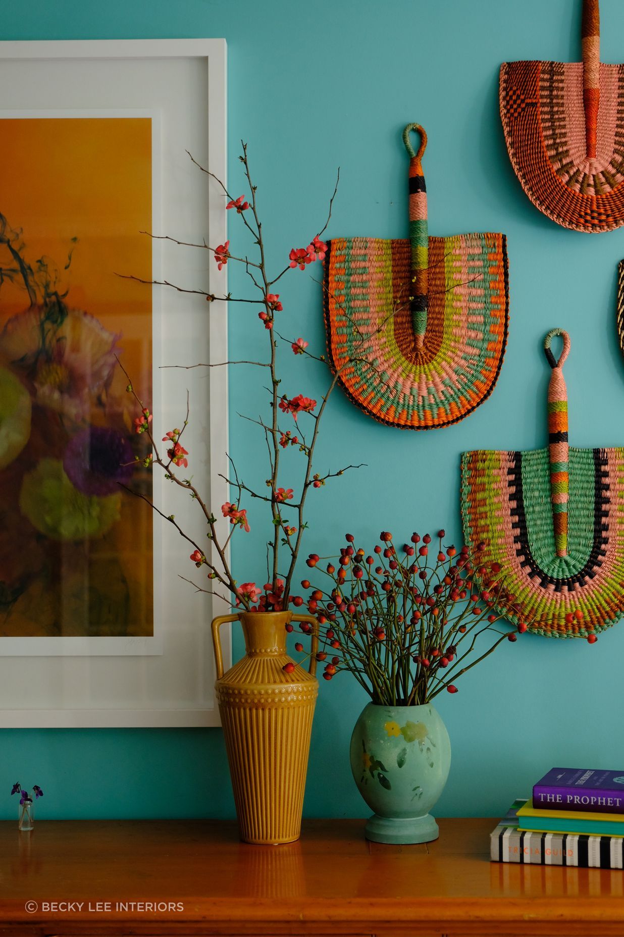 Handmade fans from Ghana looking striking against the Resene Gulf Stream wall. Artwork 'Mermaid Like' by Stacey Weaver.