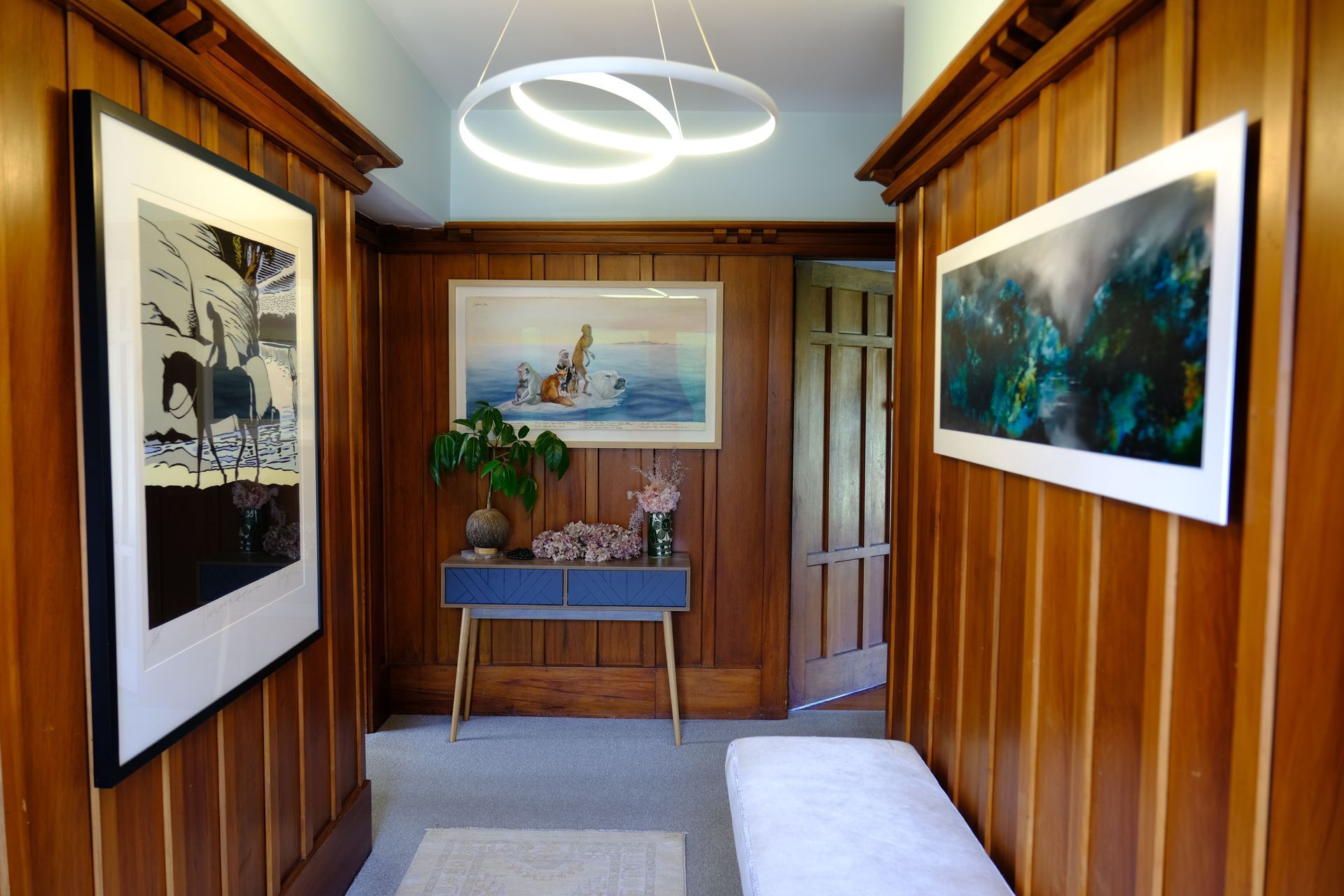 A cool pale mint paint colour was the perfect foil to the warmth of the panelling in this 1930s bungalow. We chose a very modern light fitting to disrupt the traditional feel and reference the white in the framed artworks.