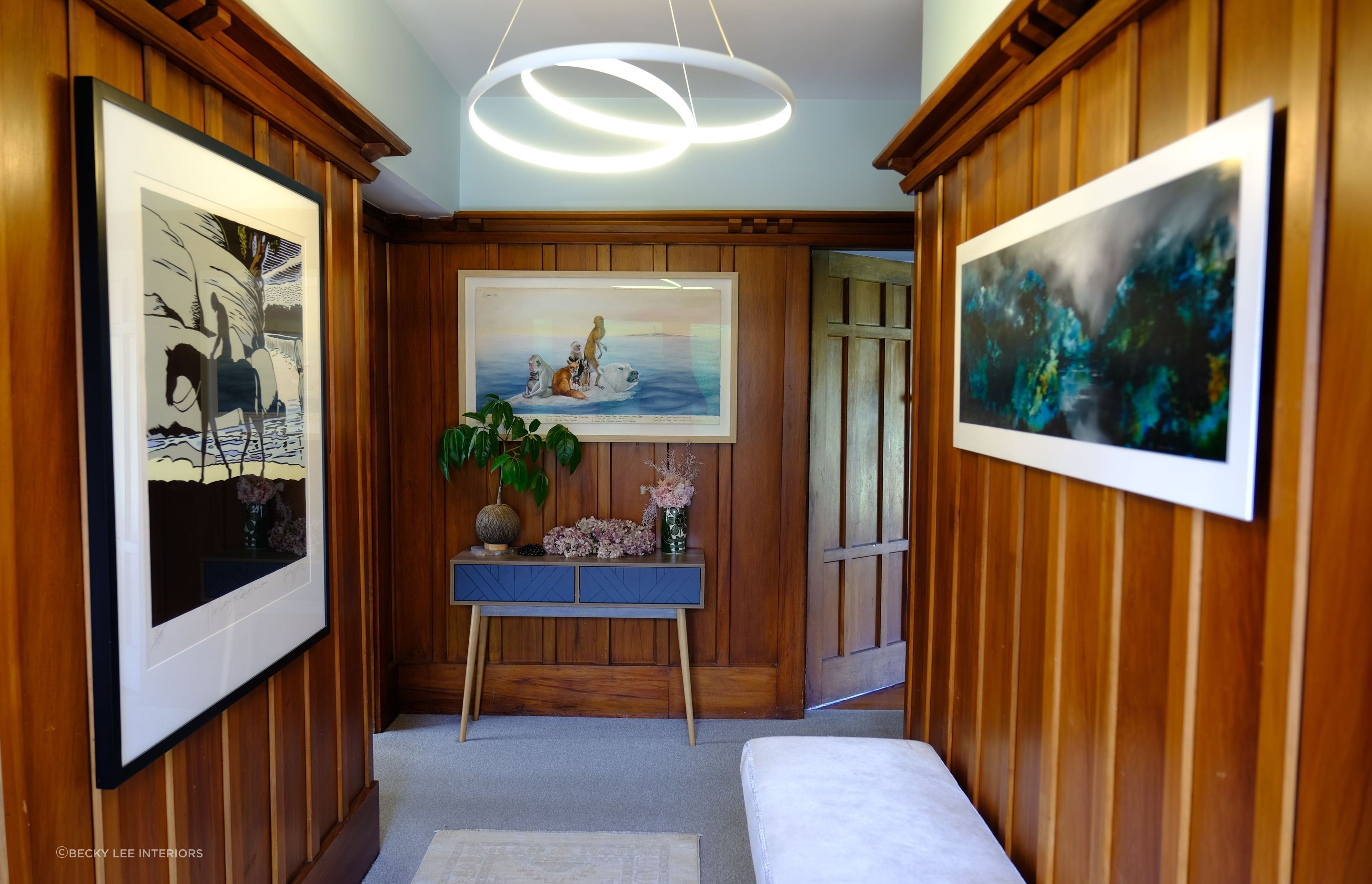 A cool pale mint paint colour was the perfect foil to the warmth of the panelling in this 1930s bungalow. We chose a very modern light fitting to disrupt the traditional feel and reference the white in the framed artworks.