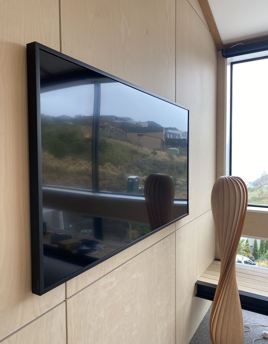Media room with amplifier hidden in wall cavity.