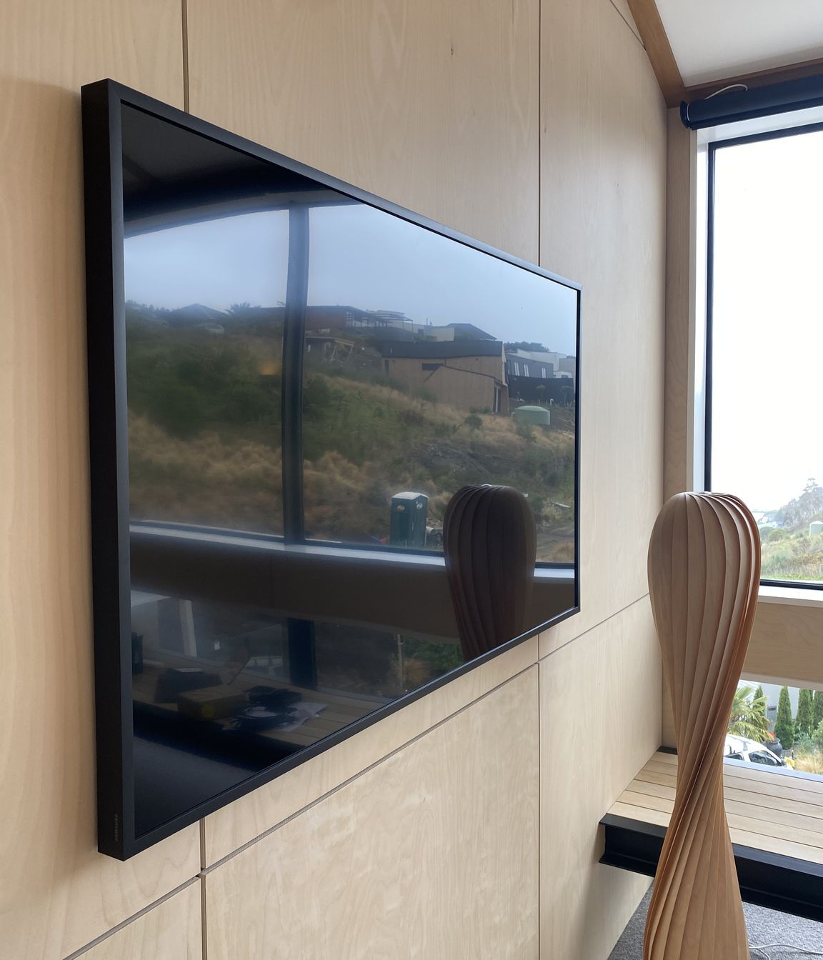 Media room with amplifier hidden in wall cavity.