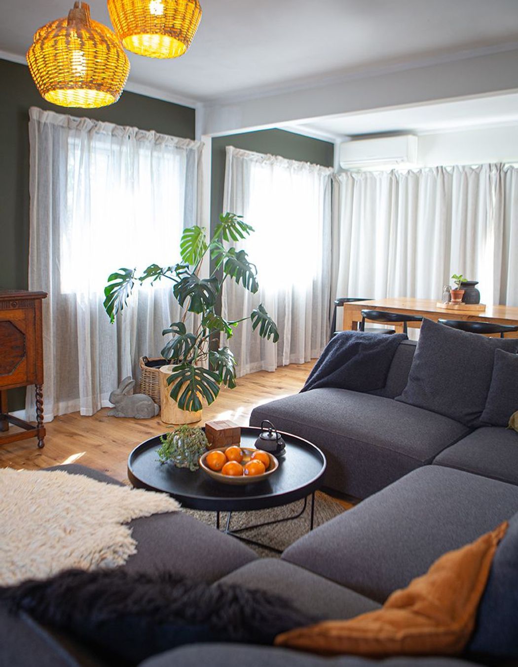 A large homely sofa for a growing family, separates the living from dining and kitchen spaces.