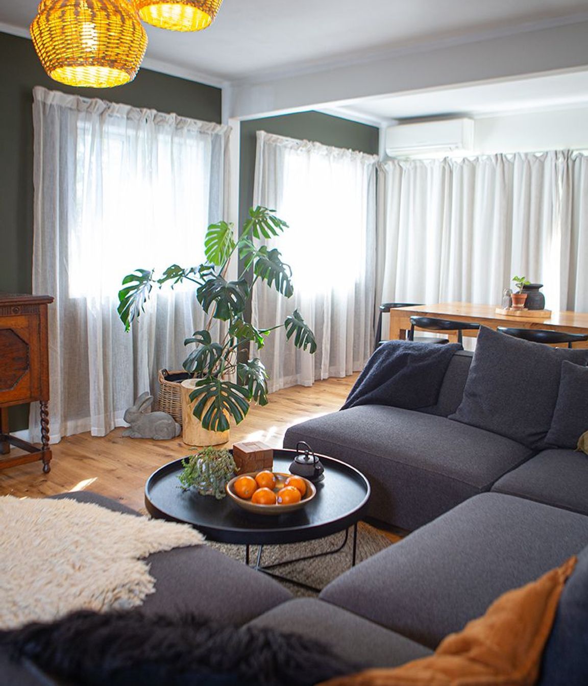 A large homely sofa for a growing family, separates the living from dining and kitchen spaces.
