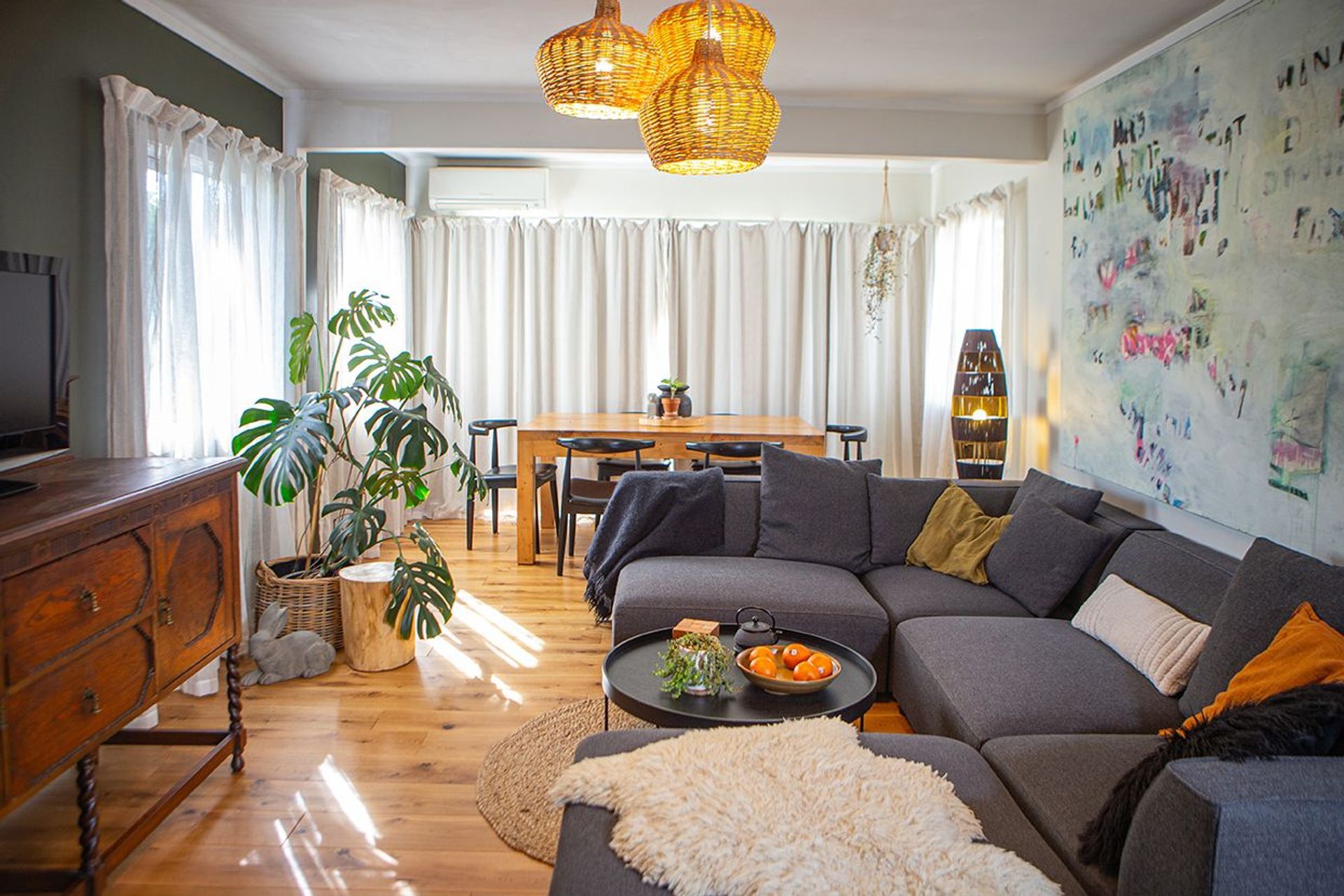 Soft drapes filter light into the living space at different times of day. Heartwood oak flooring brings additional warmth.