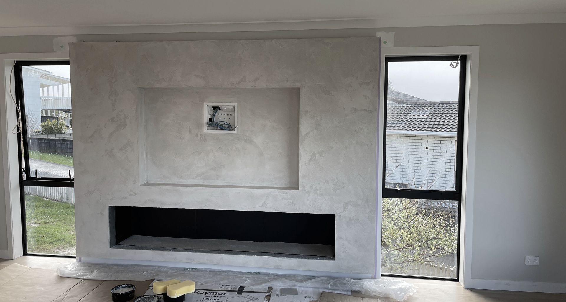 Resistone microcement fireplace banner