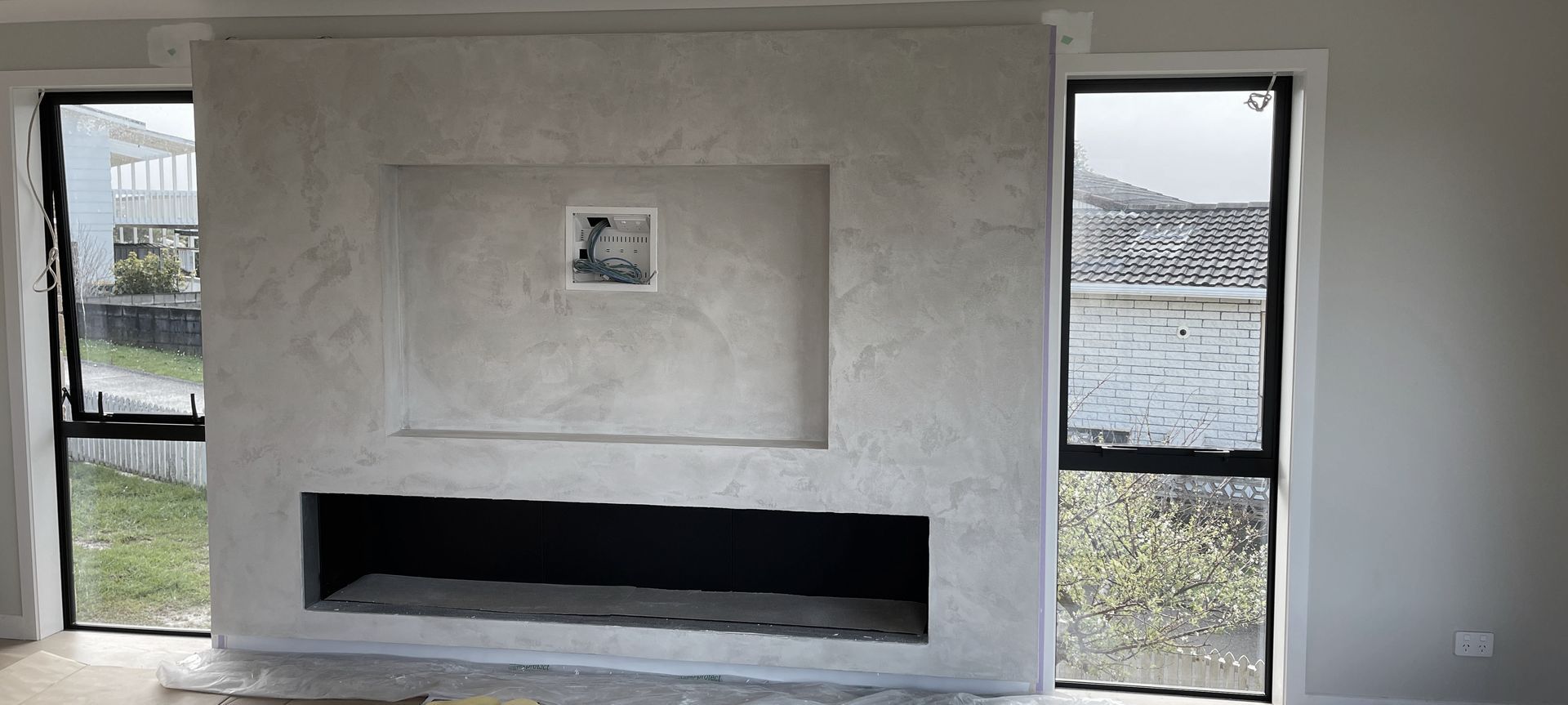 Resistone microcement fireplace banner