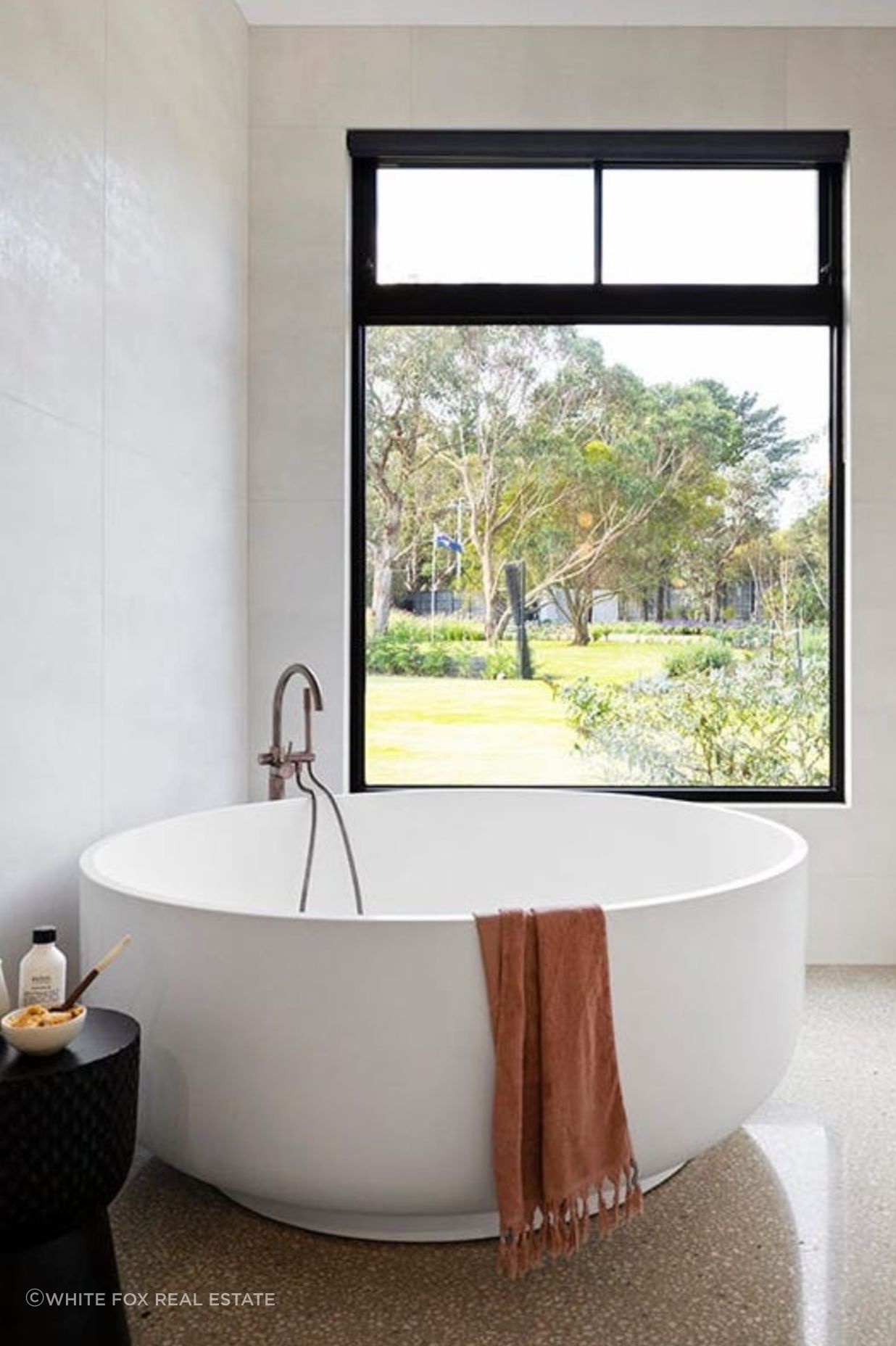 Featuring round freestanding bathtub with luscious Greenland views, this bathroom is the embodiment of relaxation