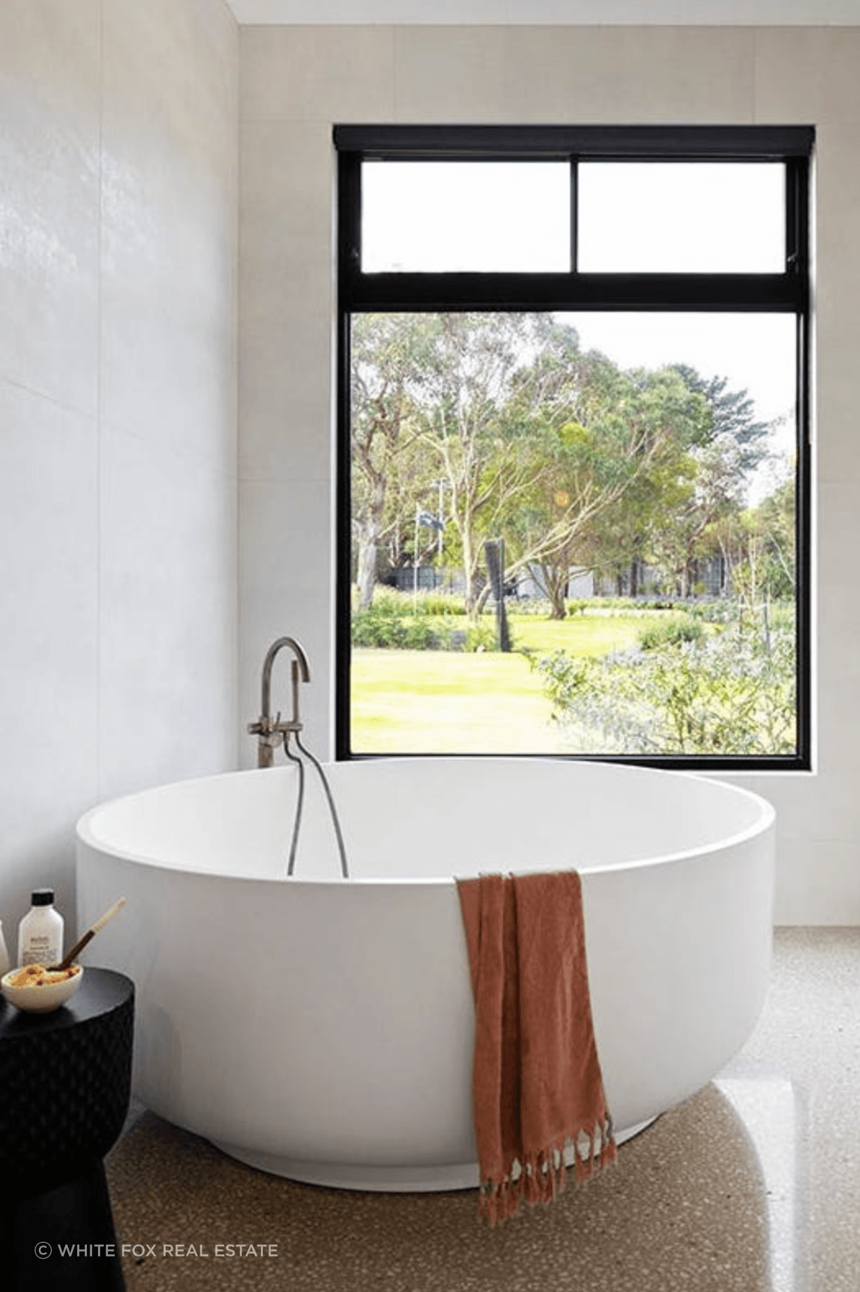 Featuring round freestanding bathtub with luscious Greenland views, this bathroom is the embodiment of relaxation