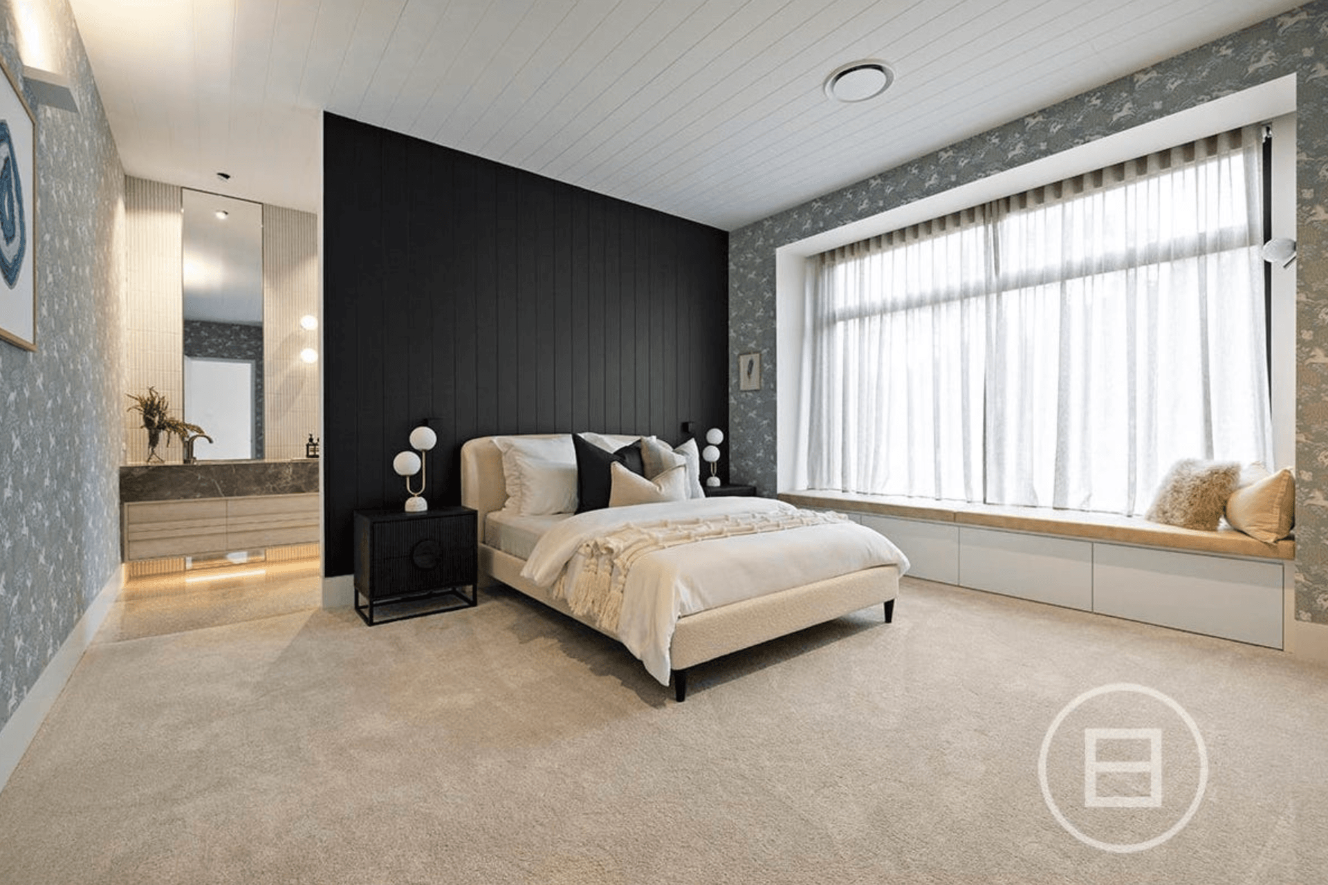 The master bedroom entrance to the ensuite is illuminated by uplights and large mirrors