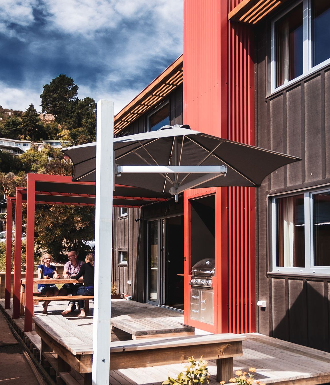 The traditional tramping hut fireplace is realised through the outdoor BBQ.