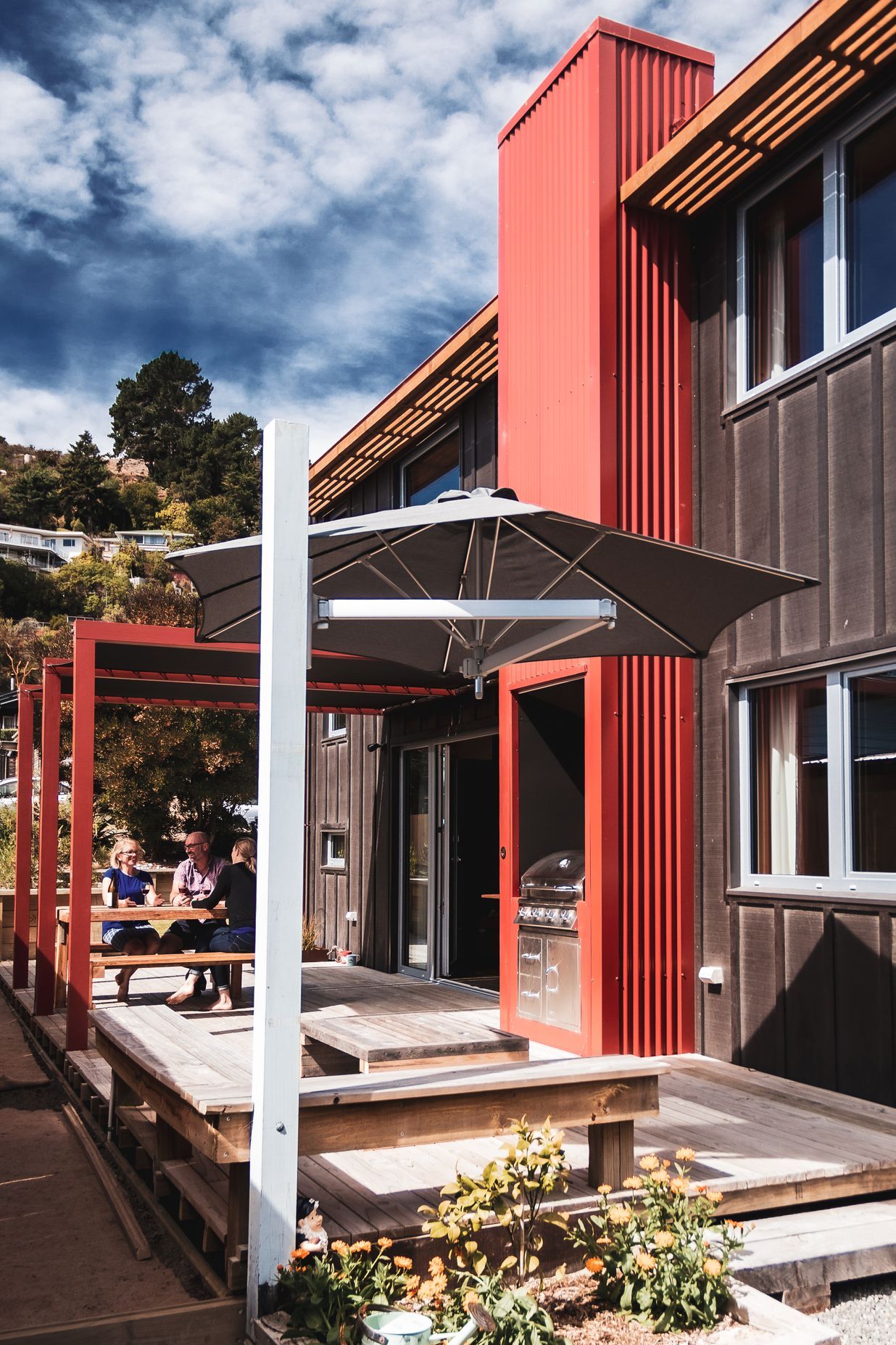 The traditional tramping hut fireplace is realised through the outdoor BBQ.