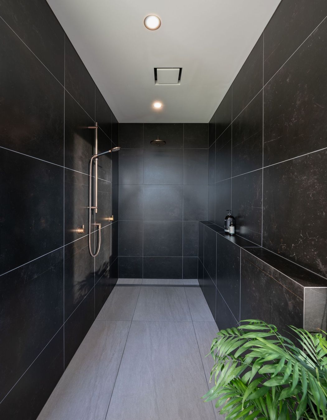 The family bathroom's shower is recessed into a private nook.