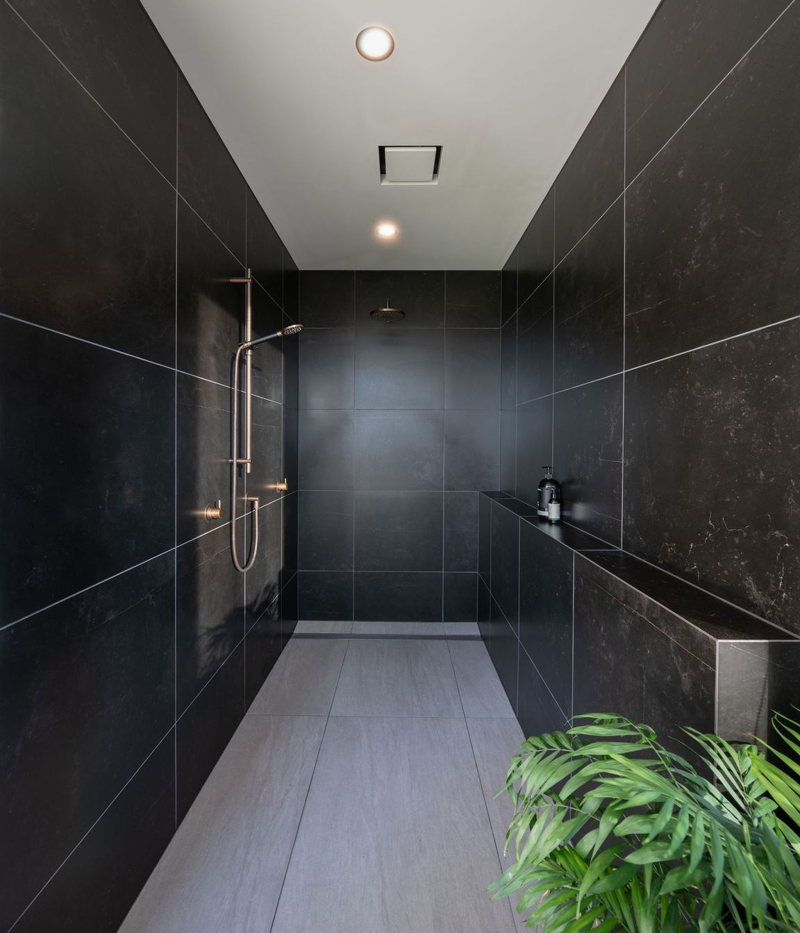 The family bathroom's shower is recessed into a private nook.
