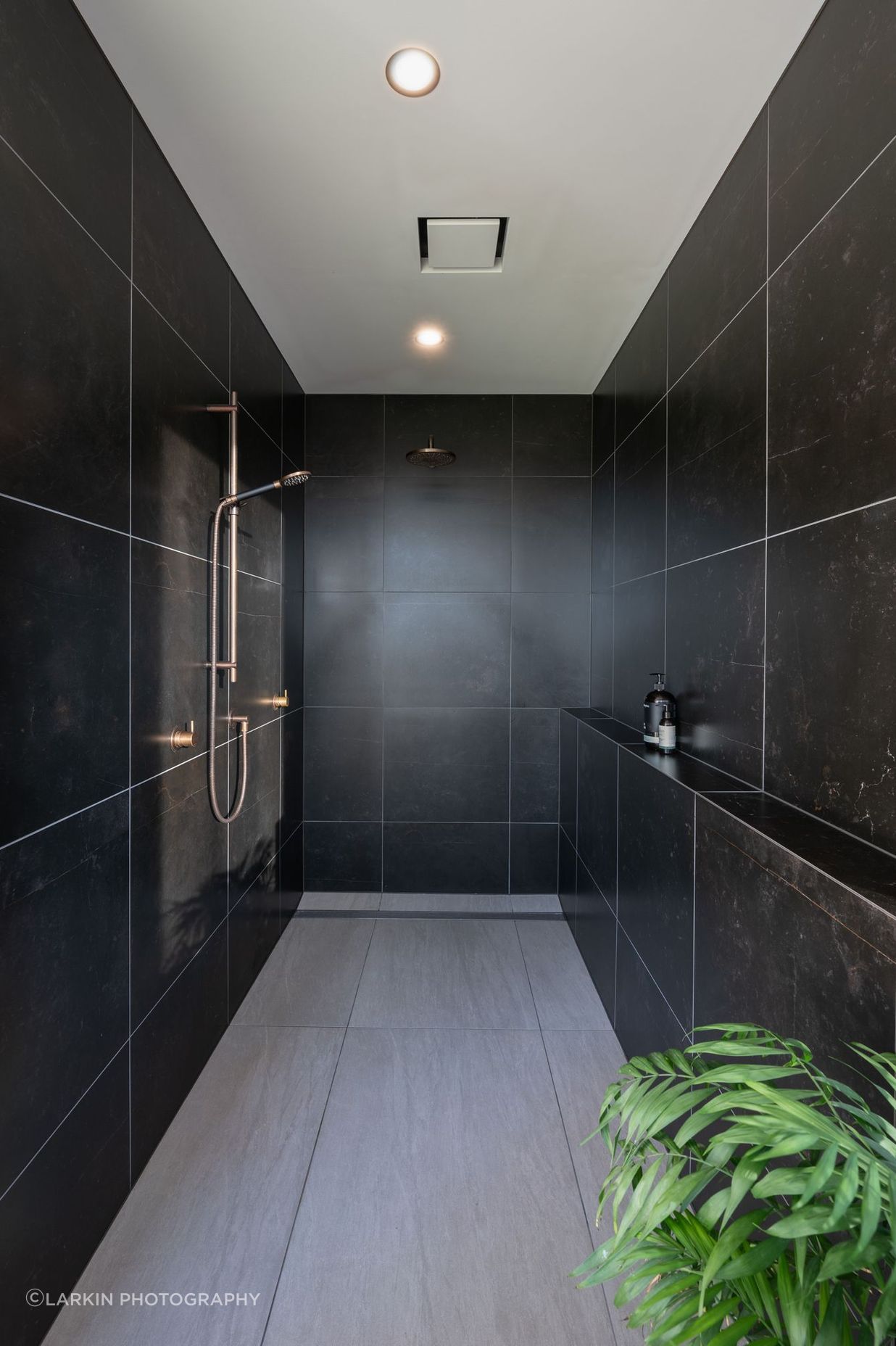 The family bathroom's shower is recessed into a private nook.