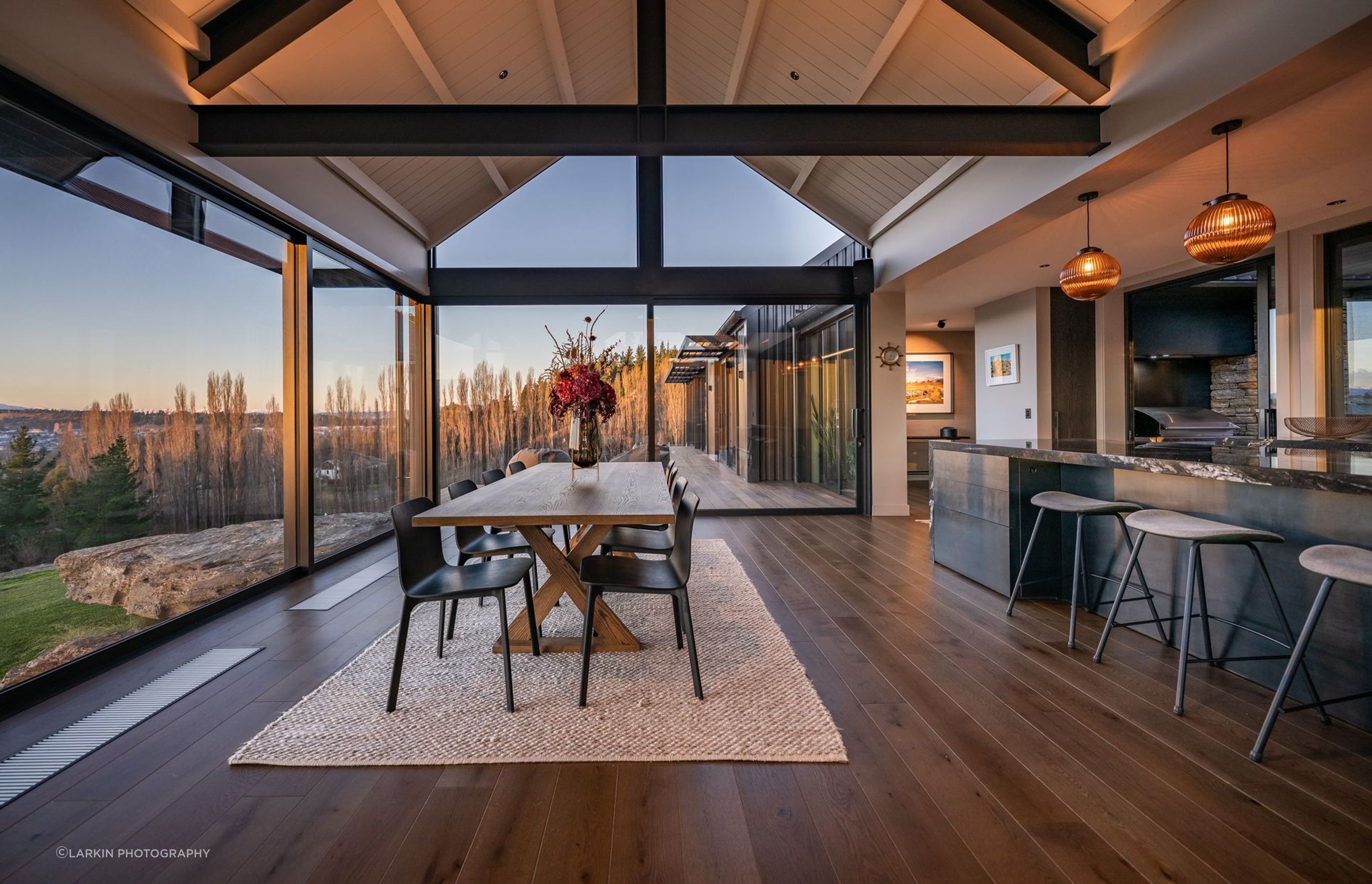 The open-plan kitchen dining enjoys panoramic views of the valley below.