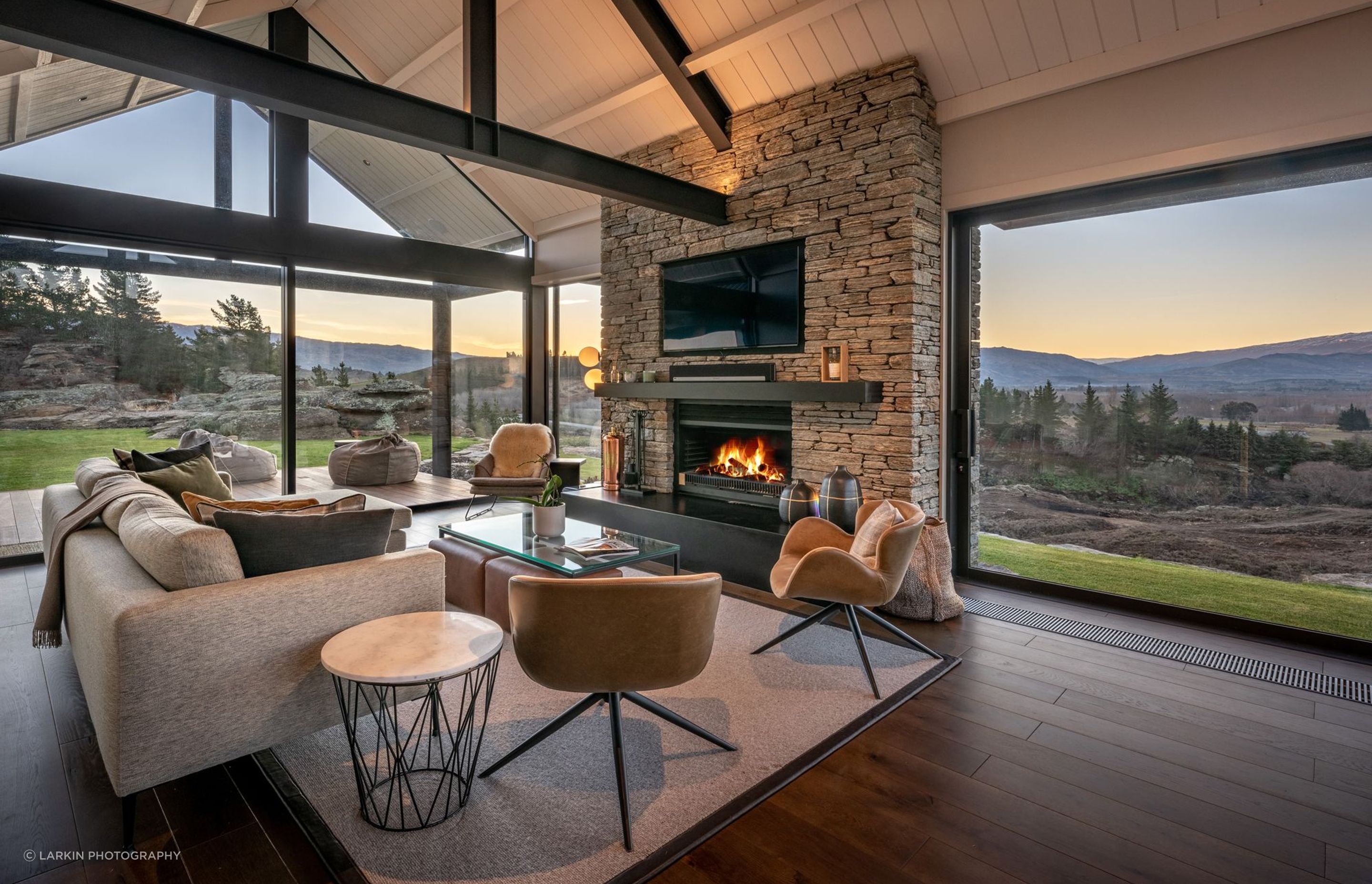 In front of the schist fireplace in the lounge is the perfect spot to relax in the evening and watch the sun set across the valley.