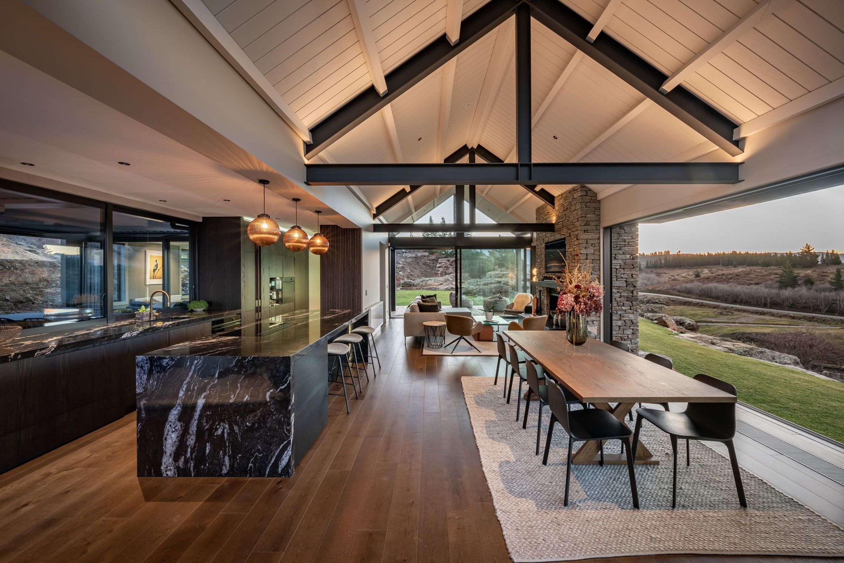 The interior features a palette that takes in the hues of the landscape and a biophilic materiality that includes schist, granite and oak.