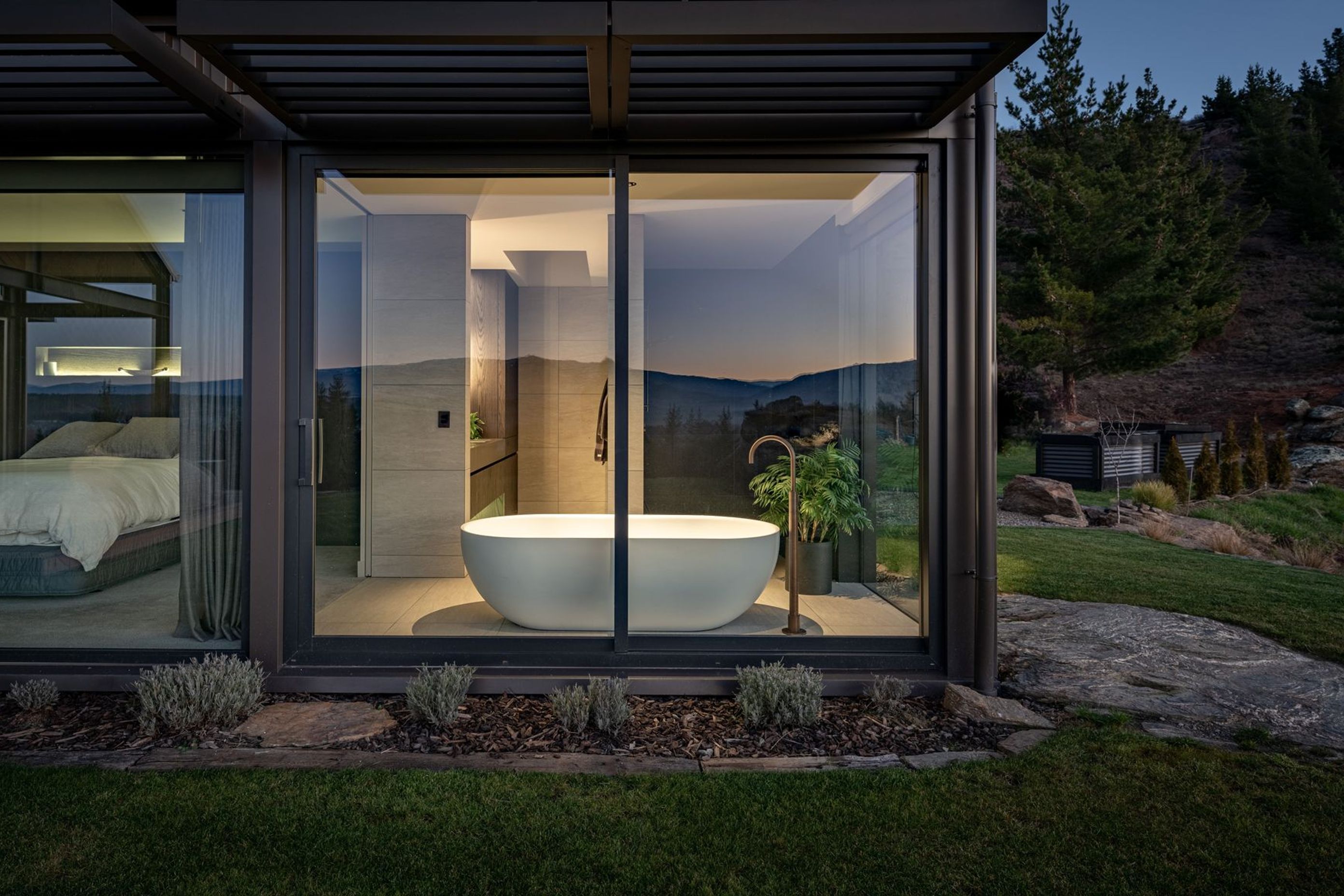 The spacious master en suite lit up at night.