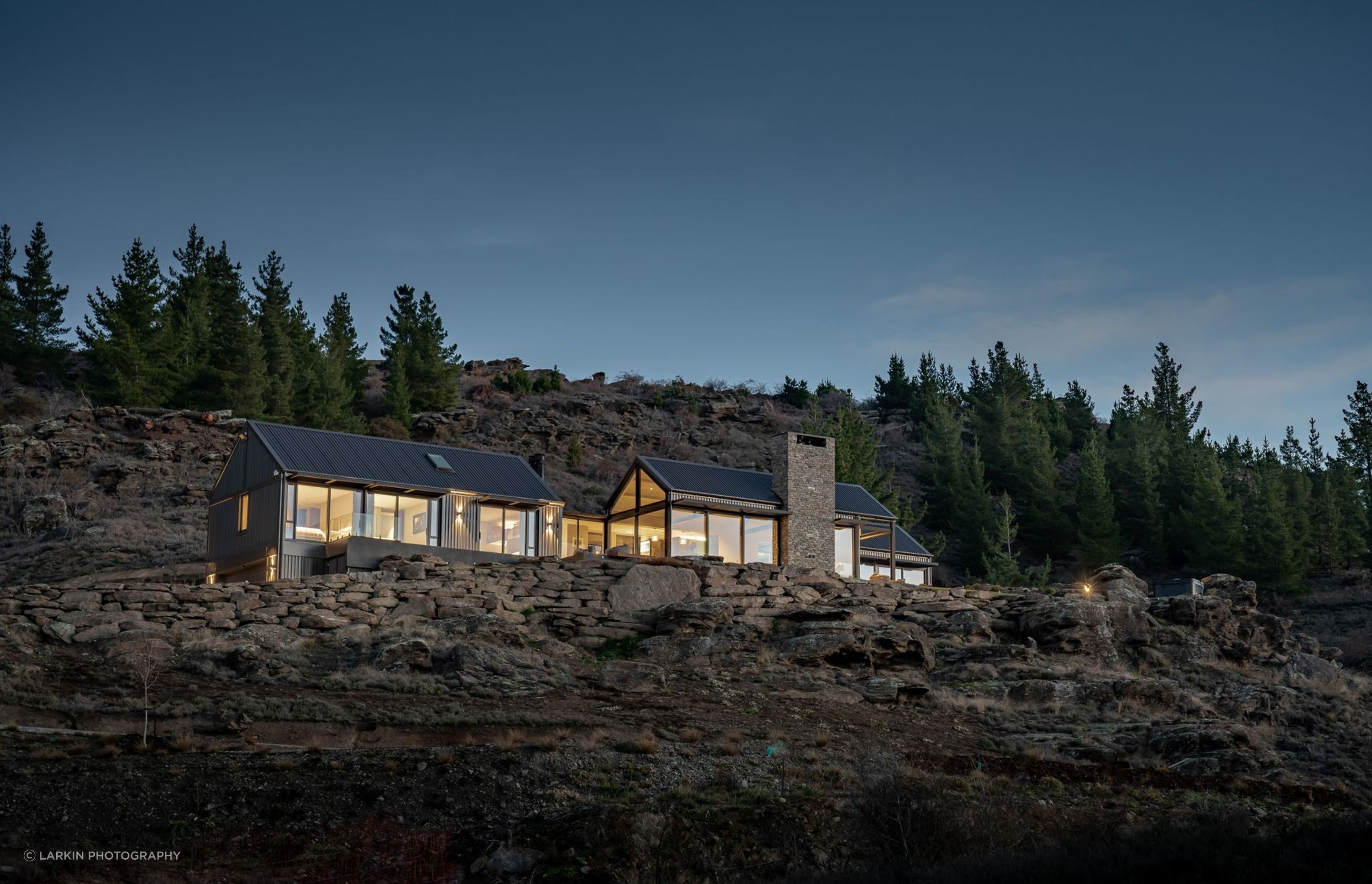 Matt says the home was "surgically implanted" into the site, and is integrated through the use of schist retaining and chimneys.