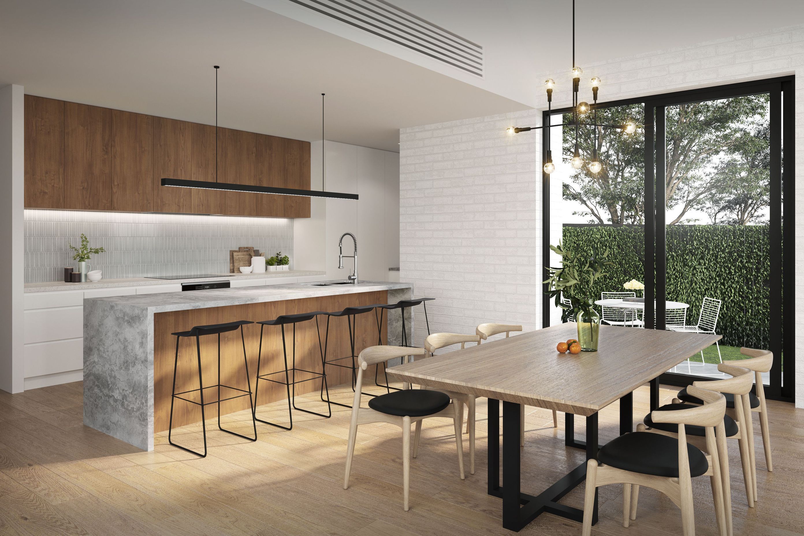 Crafted to maximise functionality and space, the open plan kitchen and dining area are anchored by an expansive stone island bench with custom joinery and statement pendant lighting.