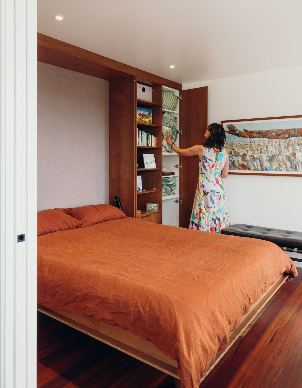 Queen size fold-away bed with in-built storage for linens.