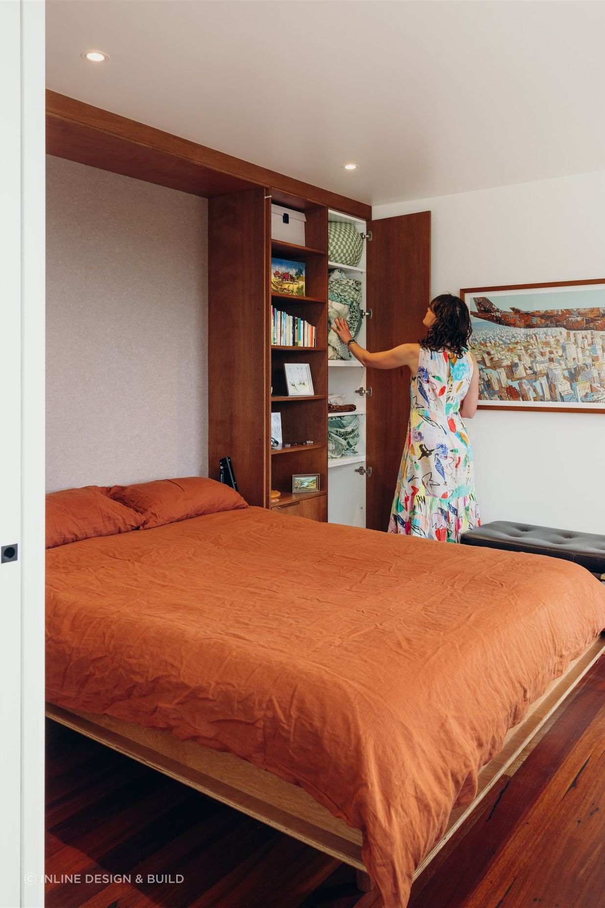 Queen size fold-away bed with in-built storage for linens.