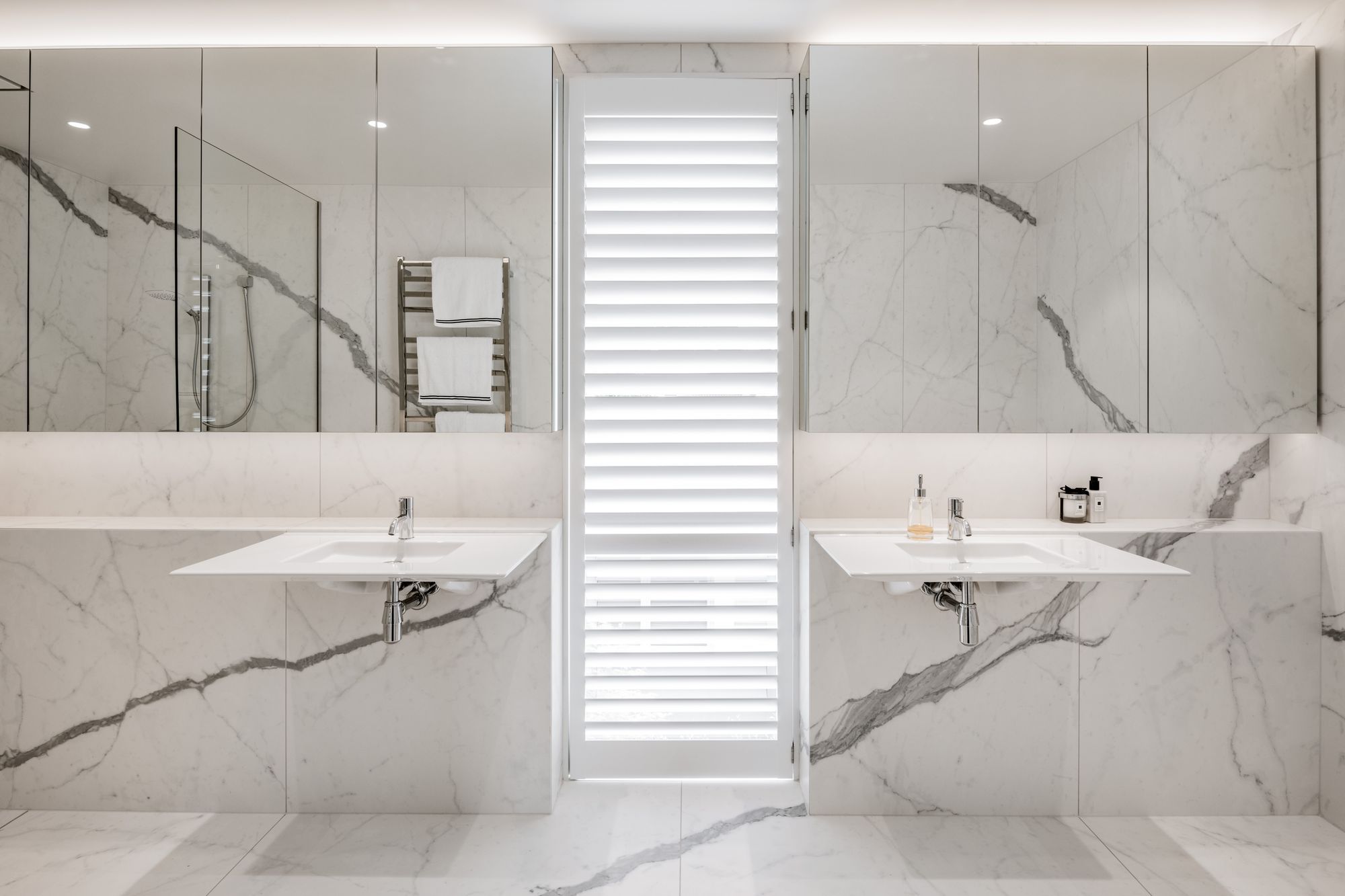 The marble from the kitchen has also been used in the main bathroom.