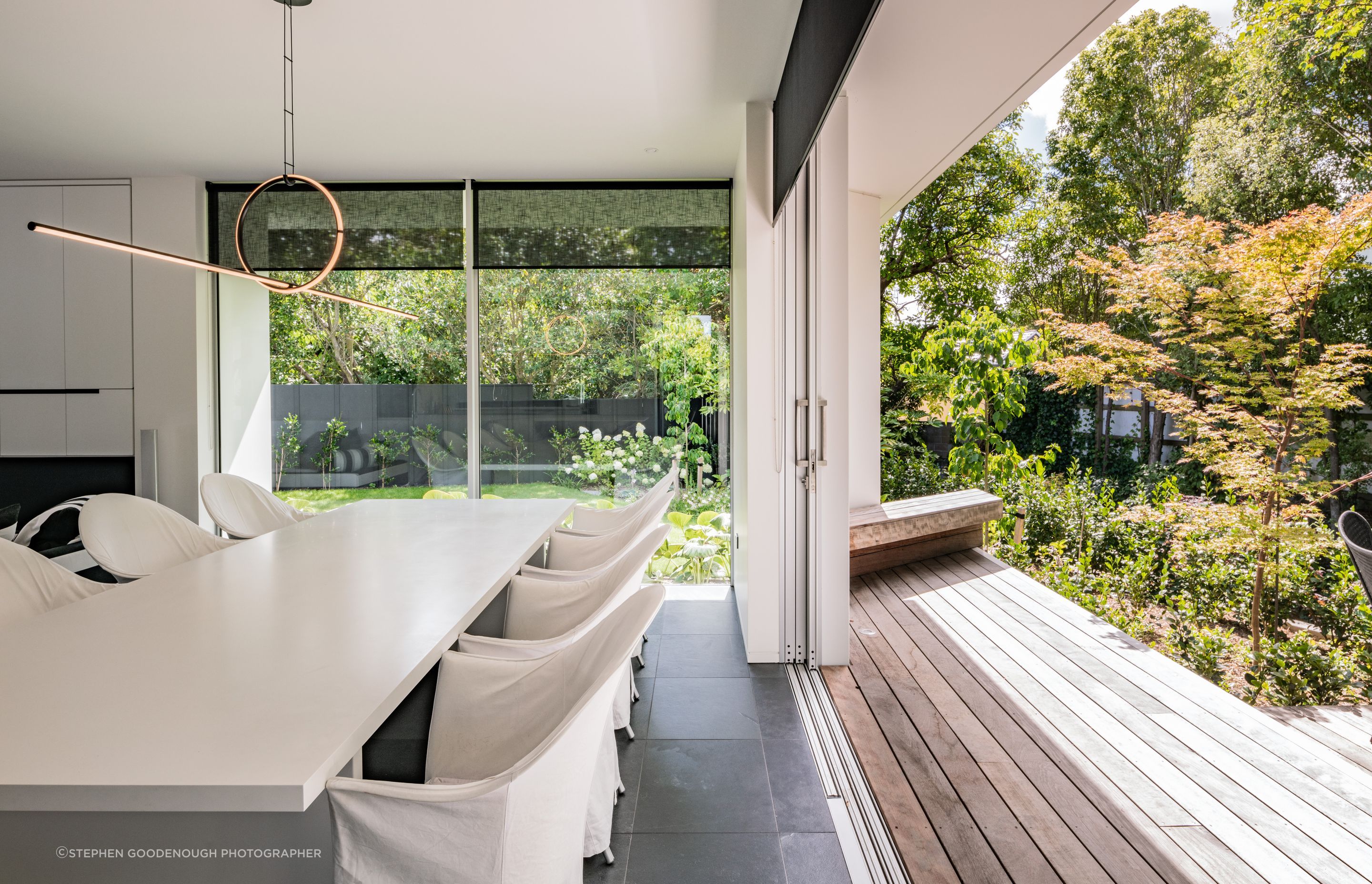 Glazing opens up so that the lush landscaping can be enjoyed from the living pavilion.