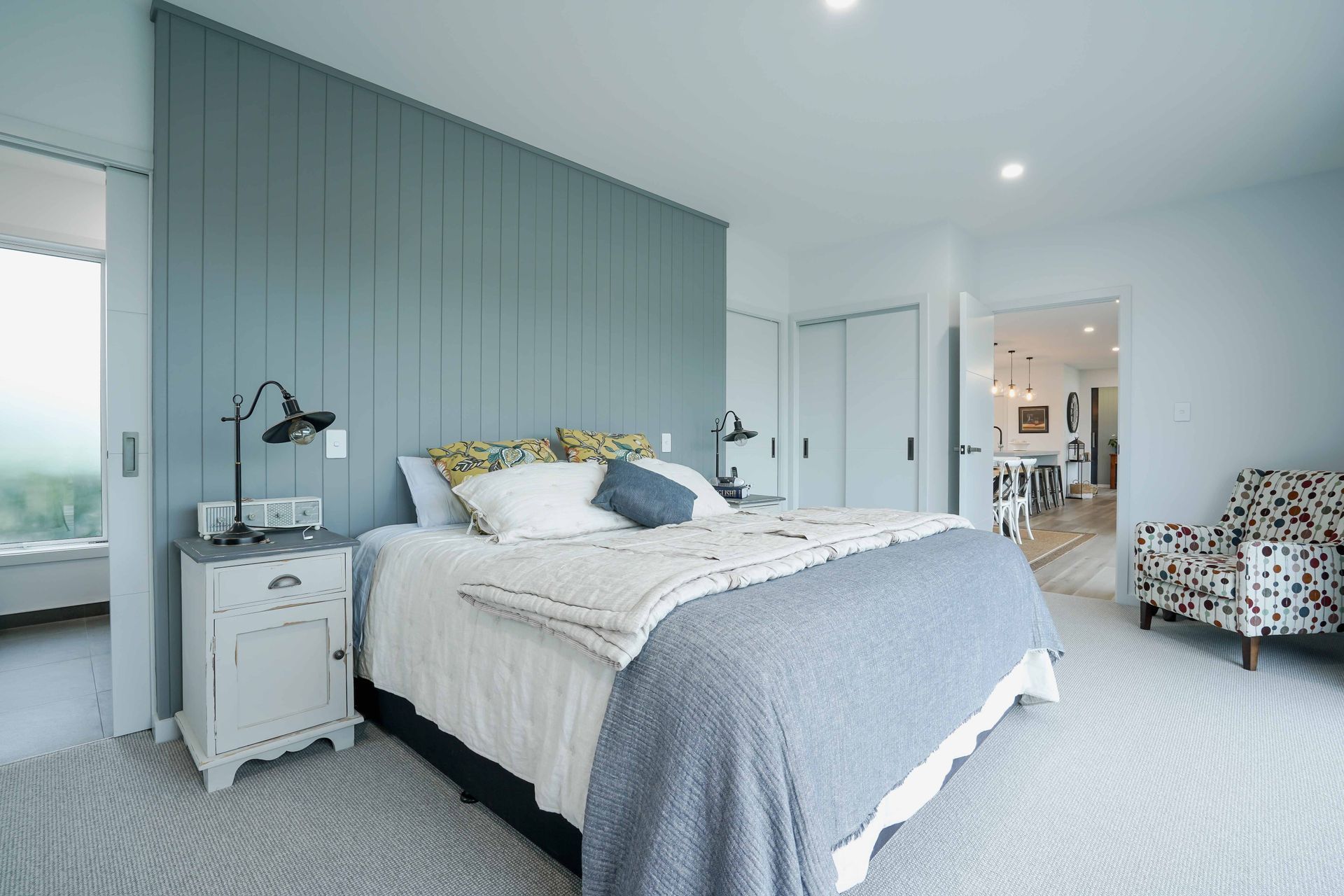 Bedroom with feature wall and ensuite behind.