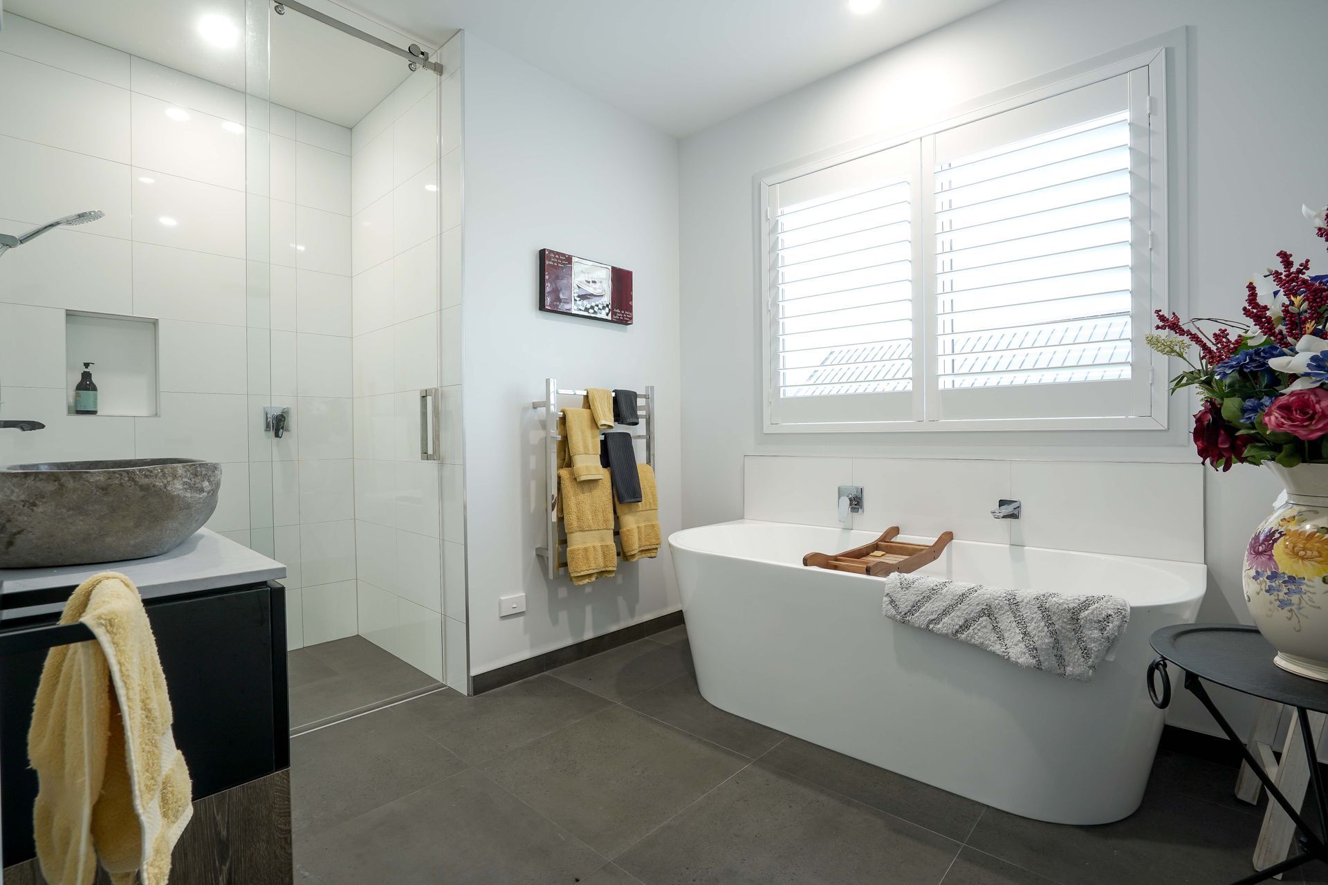 Main bathroom with freestanding bath and fully tiled shower.