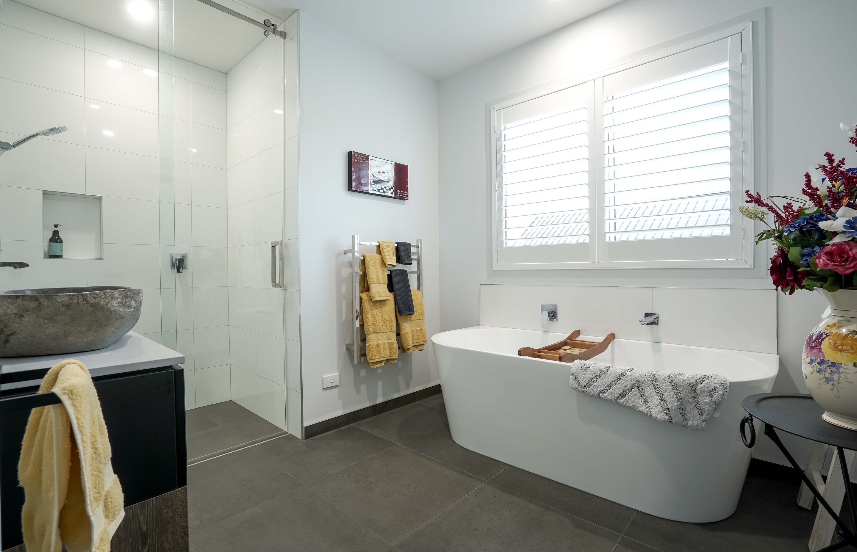 Main bathroom with freestanding bath and fully tiled shower.
