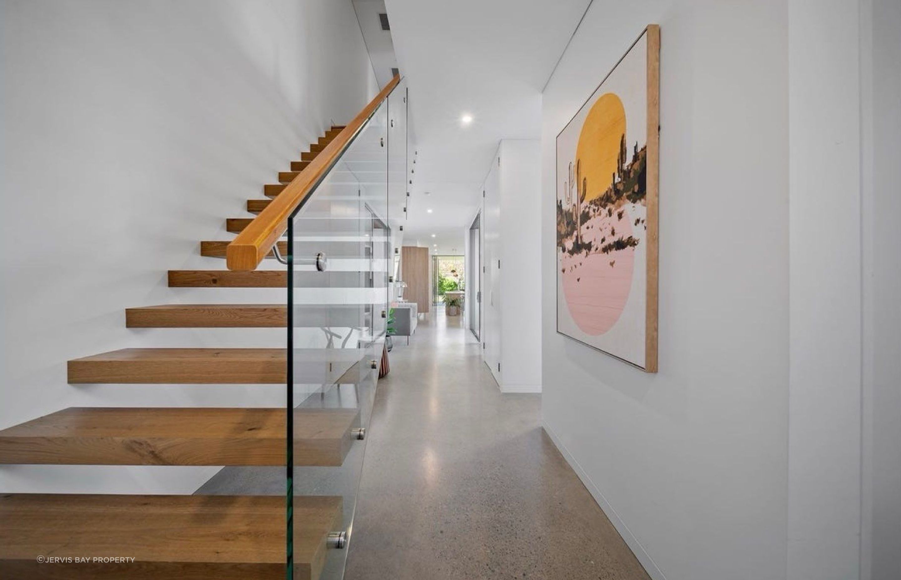 Open floating stairs to the upper floor, clean circulation all the way to the living areas.