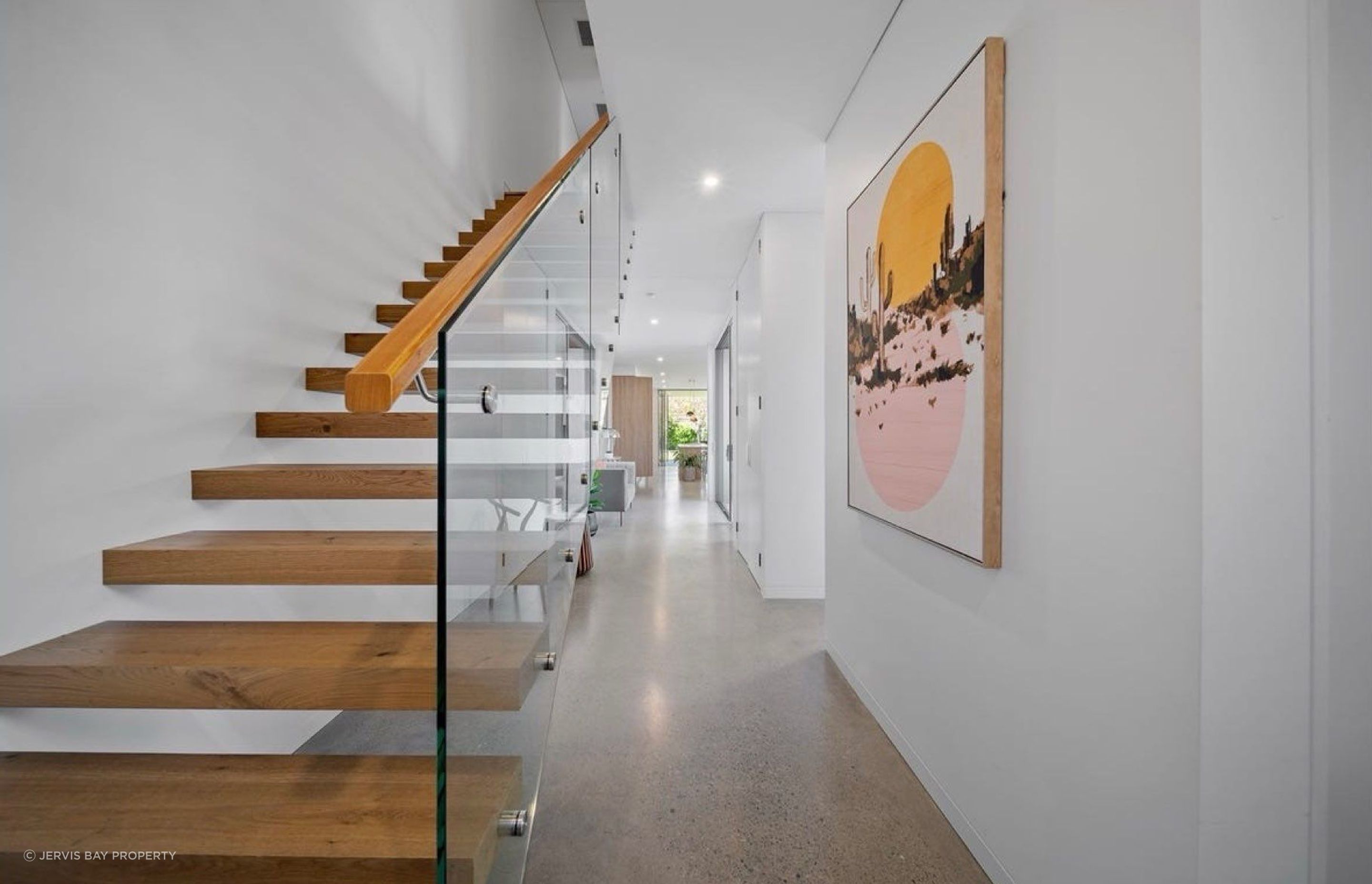 Open floating stairs to the upper floor, clean circulation all the way to the living areas.