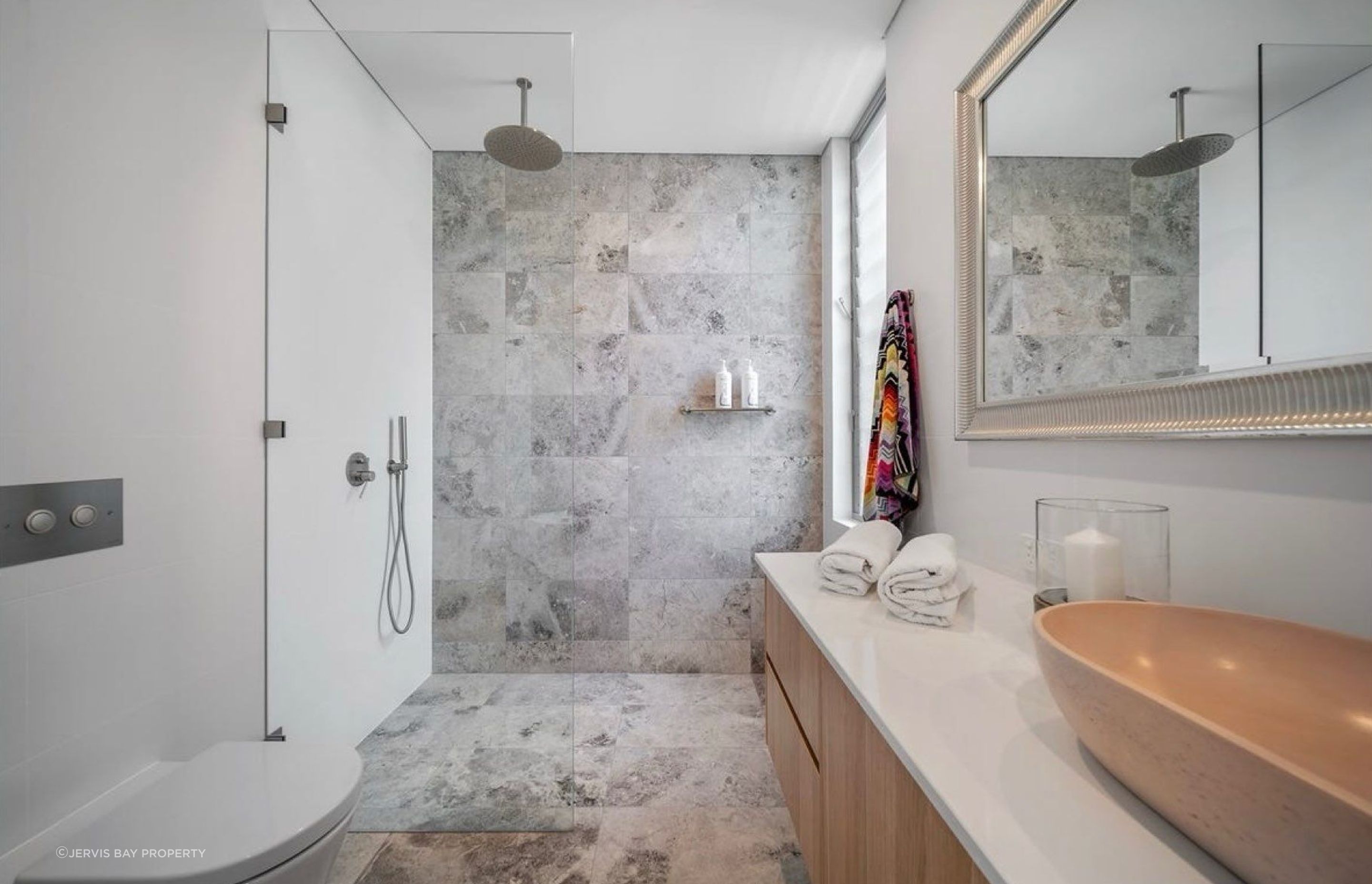 One of the three quality bathrooms in the home. Luxury appointments throughout, finishes allow for ease of maintenance for all those sandy showers